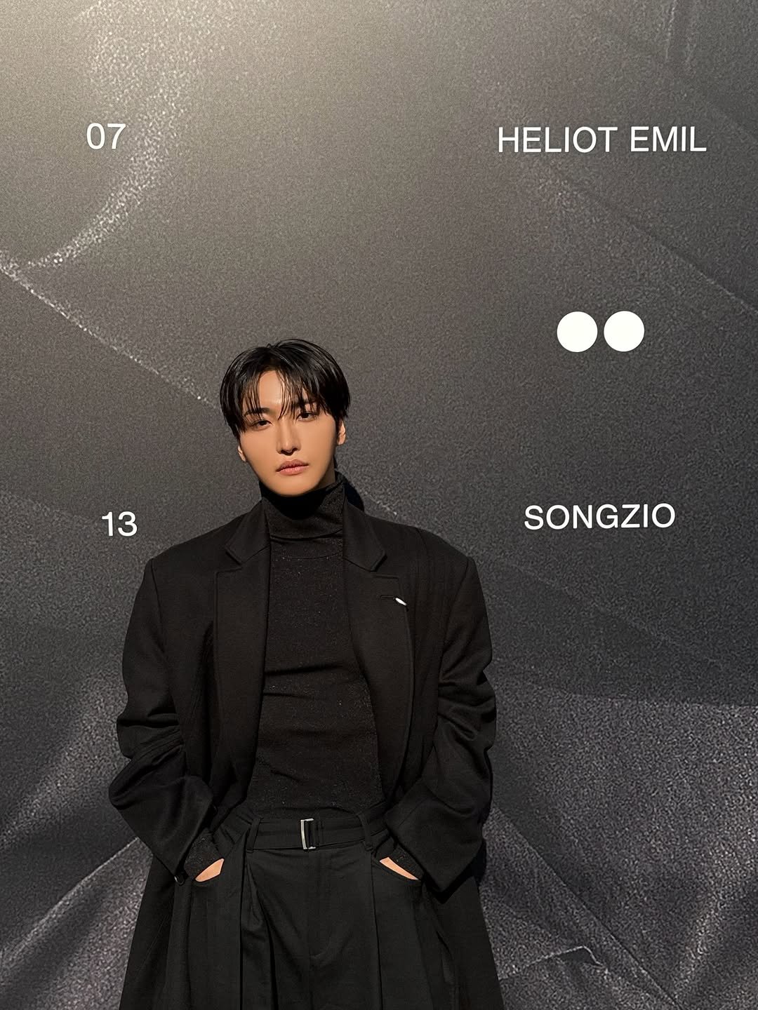 Photo shared by SEONGHWA on November 08, 2025 tagging @songzio_official. May be an image of one or more people, bangs, overcoat, duffle coat, bolo tie, turtleneck, magazine, top and text that says '07 HELIOT HELIOTEMIL EMIL 13 SONGZIO'.