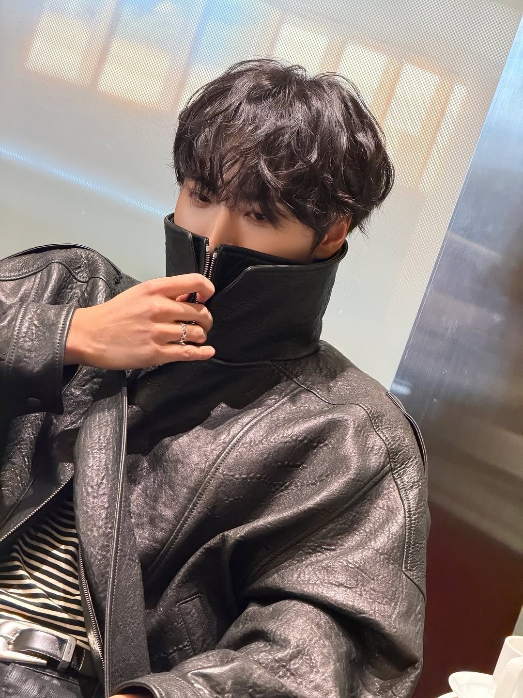 Photo by SEONGHWA on November 05, 2025. May be an image of one or more people, bangs, duffle coat, overcoat, bath robe, mannequin, turtleneck, costume and text.