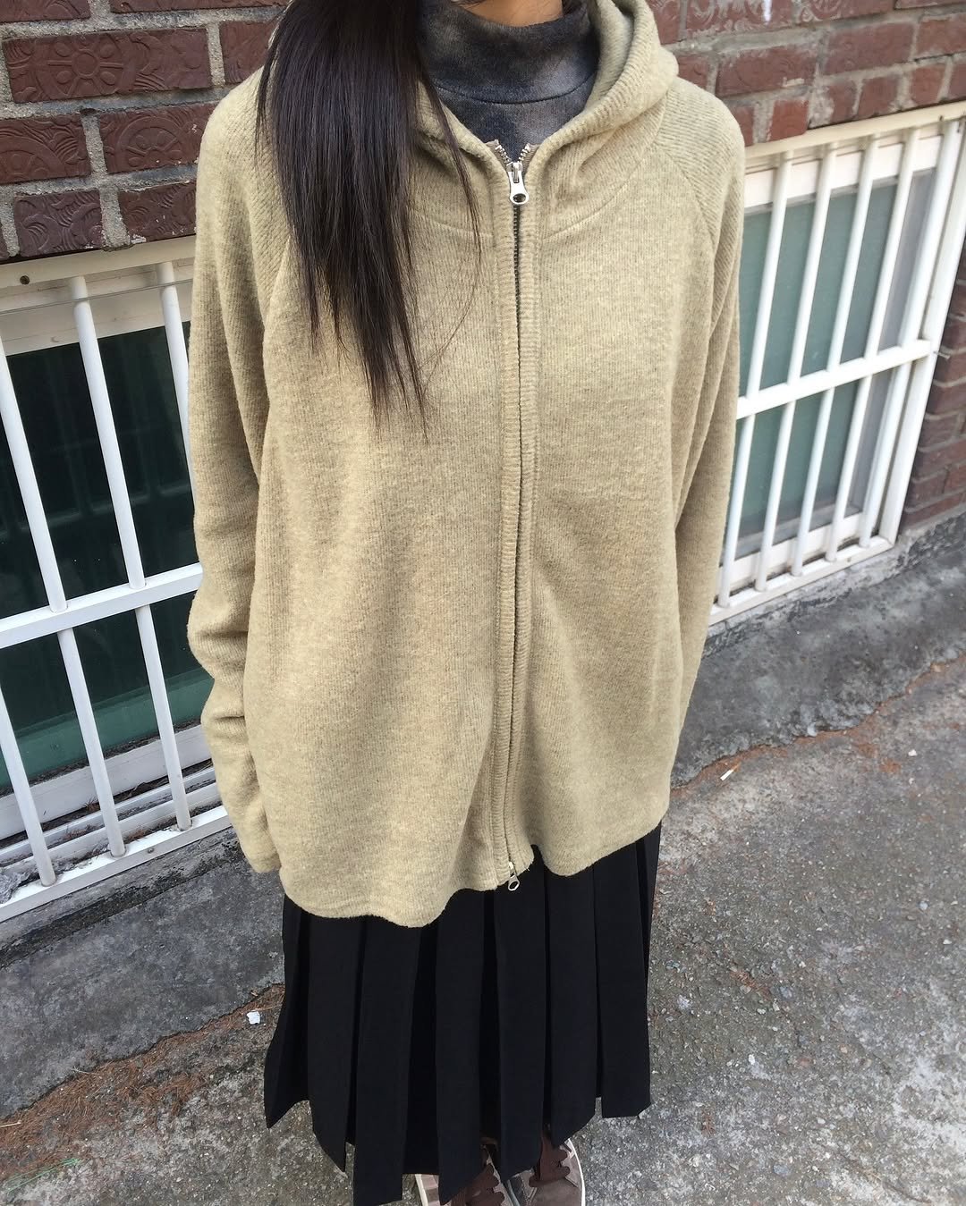 Photo by 예잇 on January 19, 2026. May be an image of overcoat, sherpa coat, fur, cloak, cardigan, turtleneck, sweater, fleece and text.