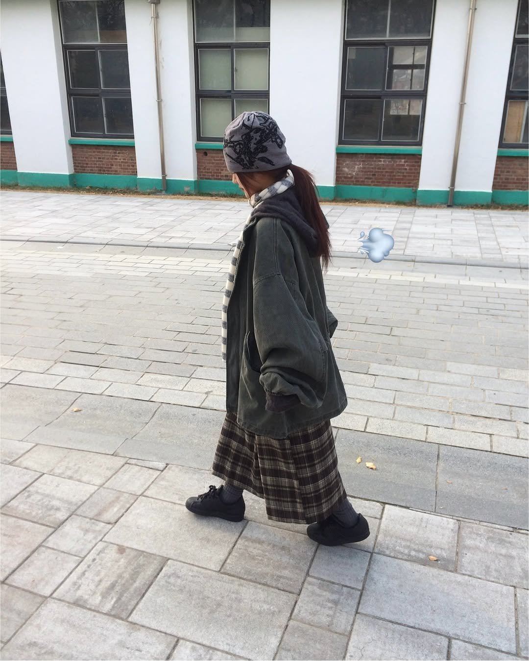 Photo by 예잇 on November 26, 2025. May be an image of one or more people, braids, overcoat, duffle coat, flannel, headscarf, parka, kilt, cloak, beret, jacket, street and text.