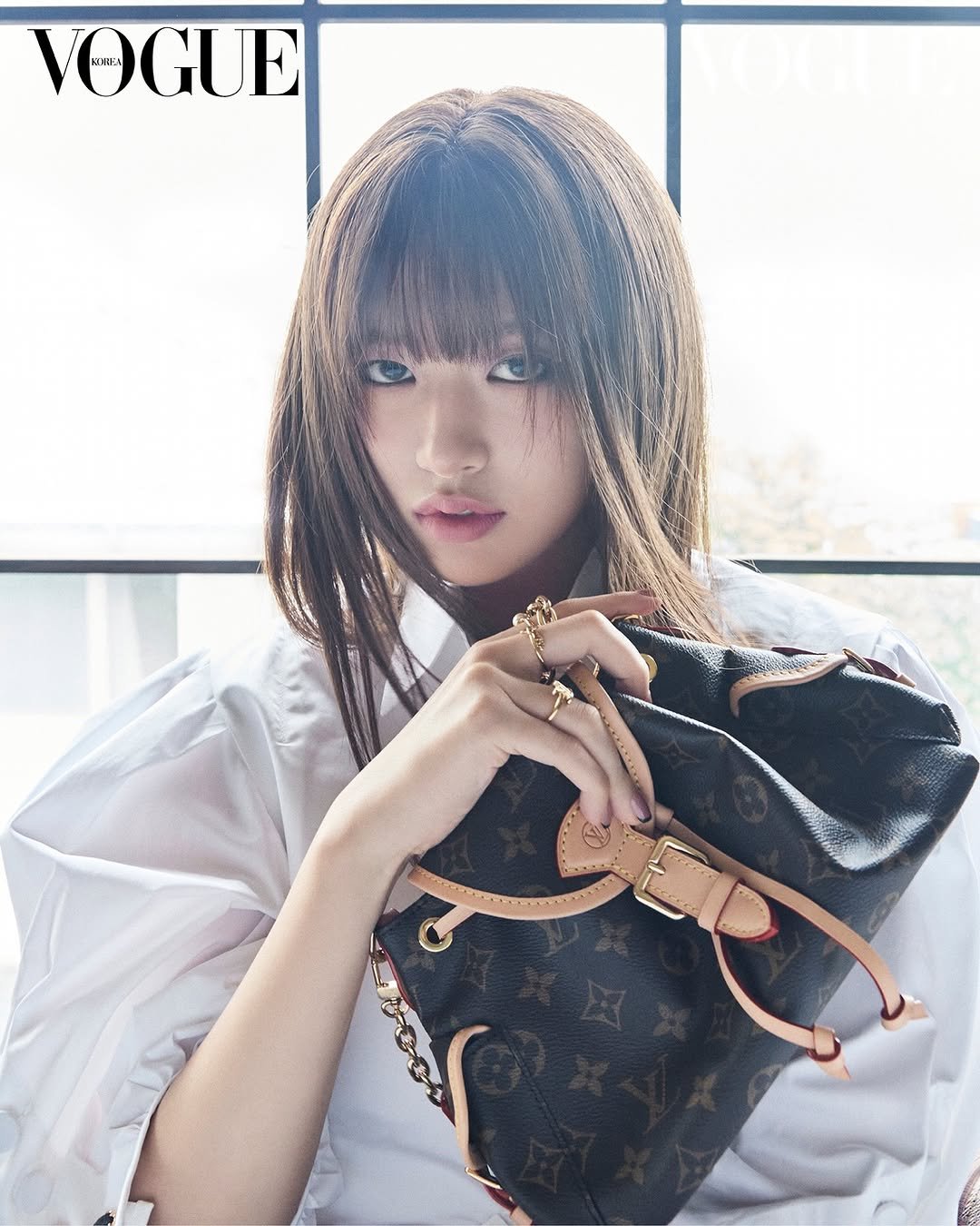 Photo shared by 안유진 AN YUJIN on July 24, 2025 tagging @voguekorea. May be an image of 1 person, magazine, purse and text that says 'VOGUE'.