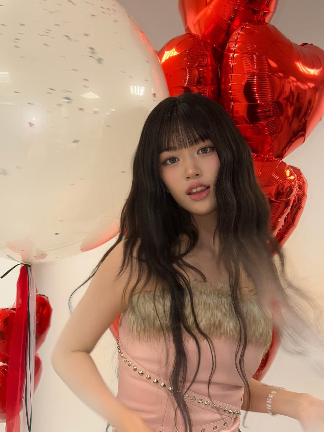 Photo by 안유진 AN YUJIN on December 12, 2025. May be an image of one or more people, hair, balloon, dress and text.