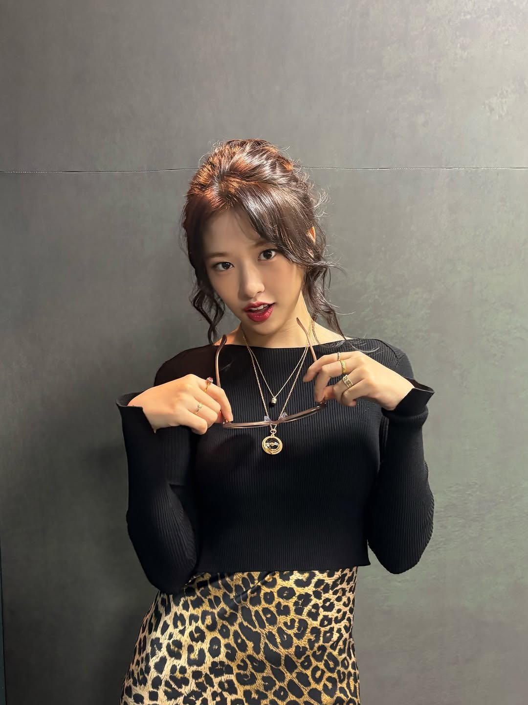 Photo by 안유진 AN YUJIN on October 07, 2025. May be an image of 1 person, braids, fishnet stockings, top, turtleneck, miniskirt and text.