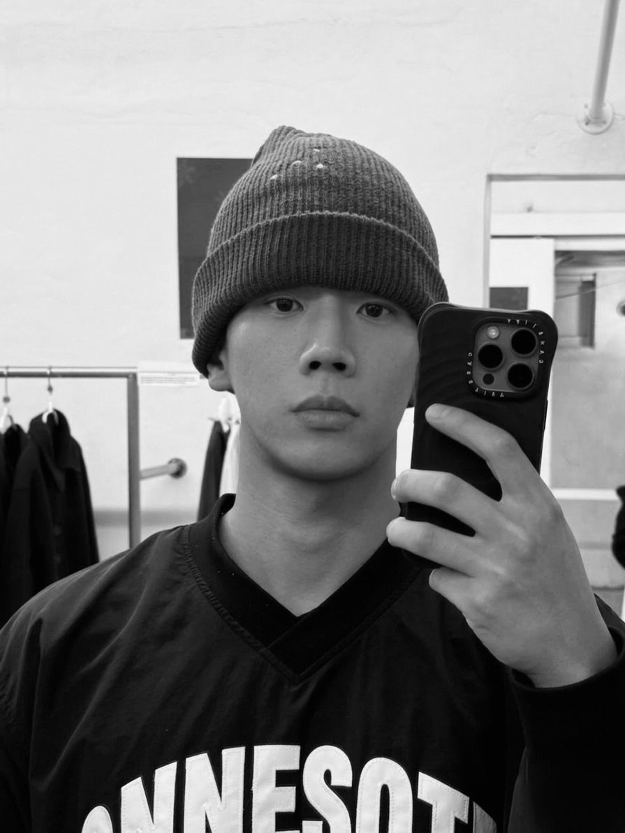 Photo by JIKWON on March 15, 2026. May be a black-and-white image of one or more people, hat, mirror and text.