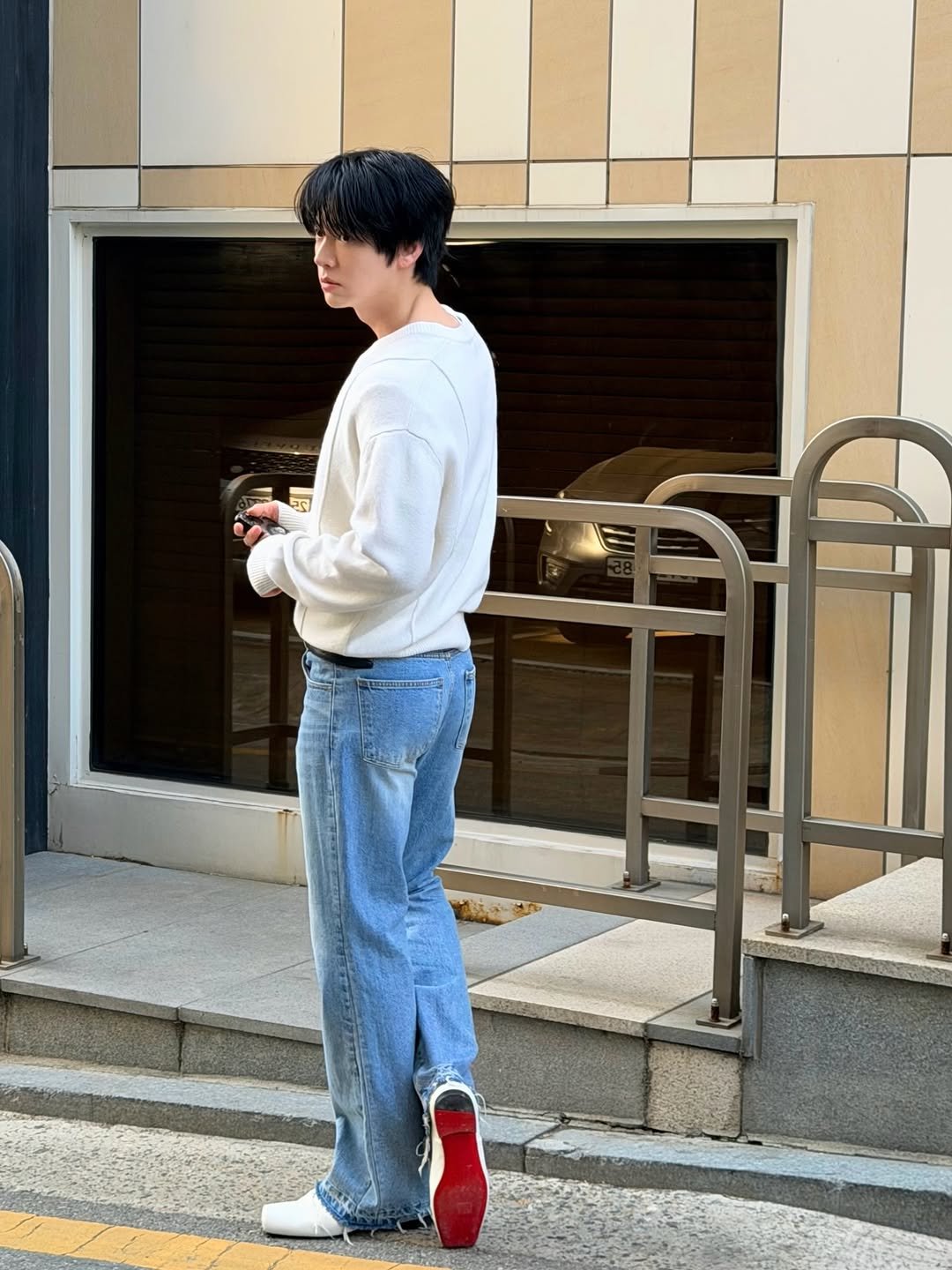 Photo shared by 안재현 on March 24, 2026 tagging @christianlouboutin. May be an image of one or more people, cigarette, street and text.