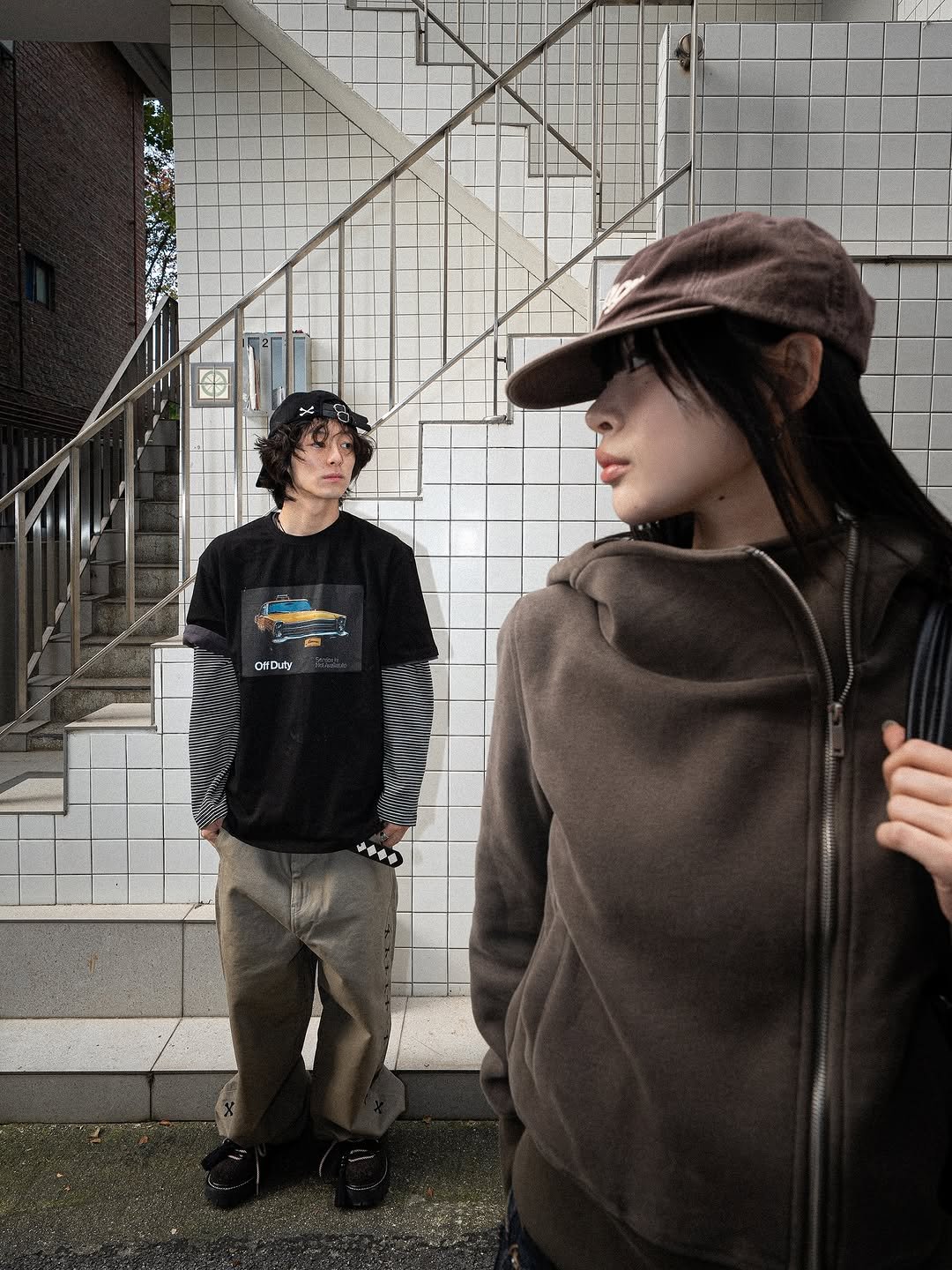 Photo by AAOA on October 29, 2025. May be an image of one or more people, duffle coat, hat, parka, street and text.