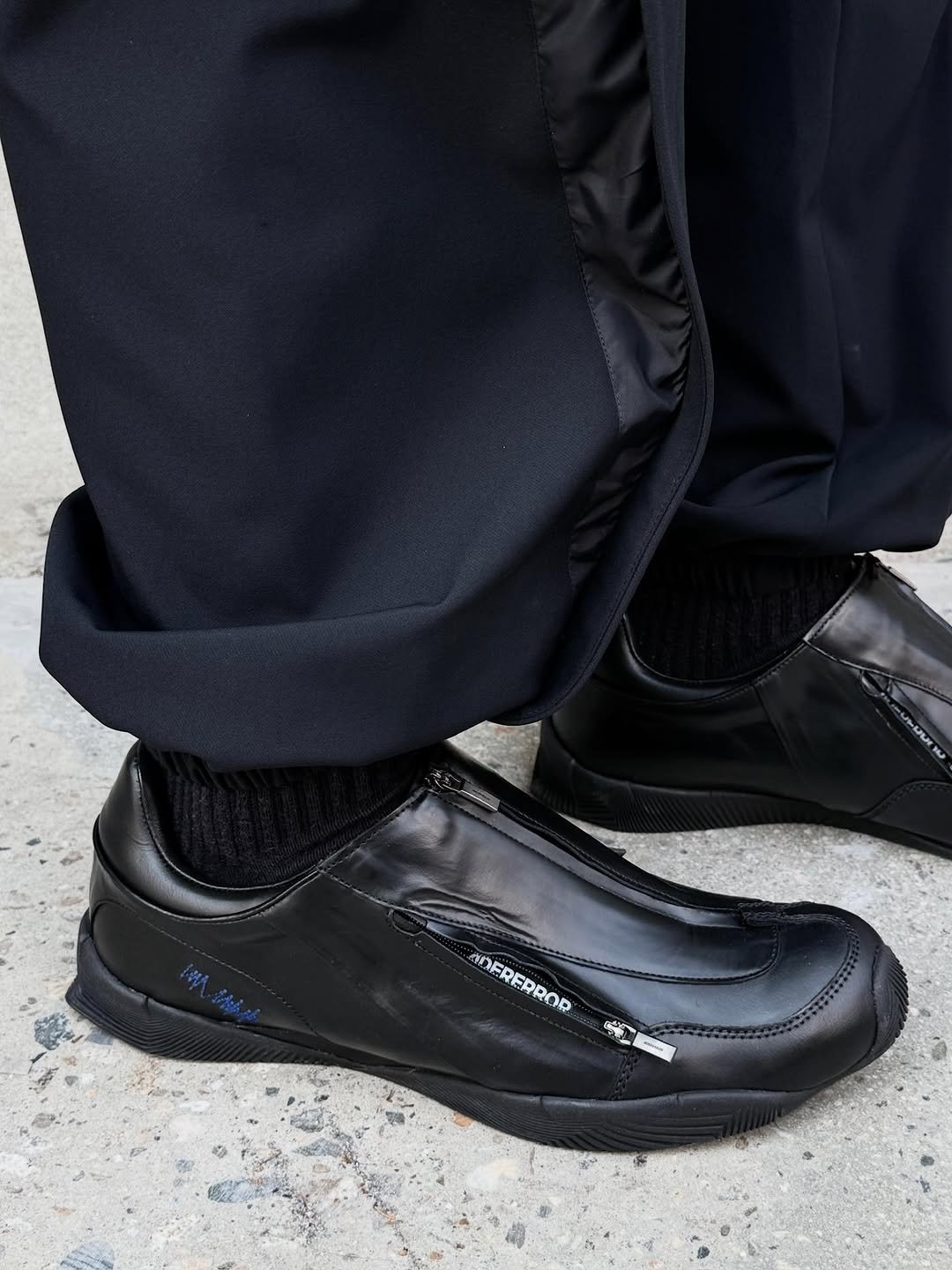 Photo by ADERERROR SPACE on November 23, 2025. May be an image of wingtip shoes, toecap shoes, loafer and text.