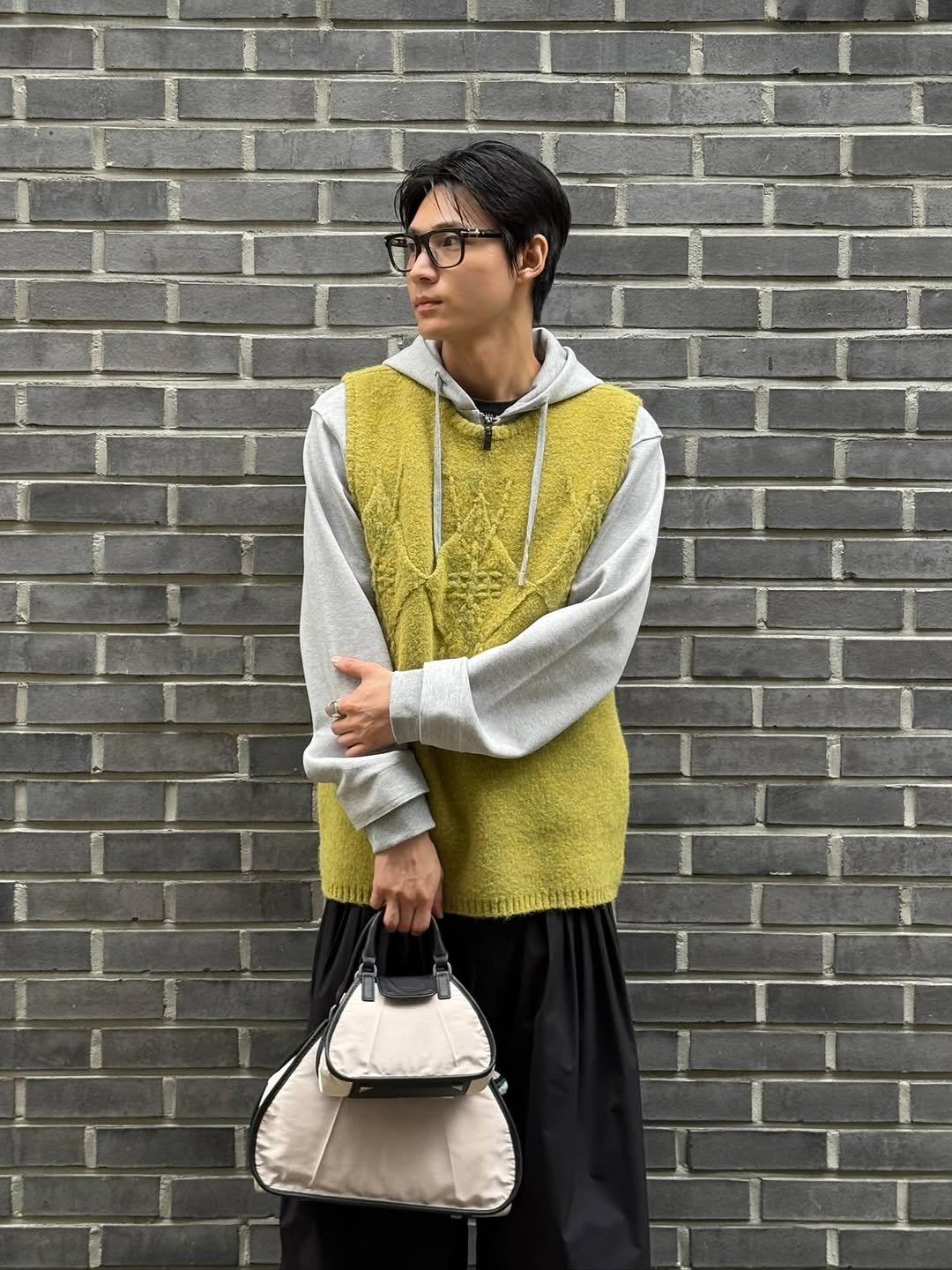 Photo by ADERERROR SPACE on October 15, 2025. May be an image of parka, turtleneck, cardigan and text.