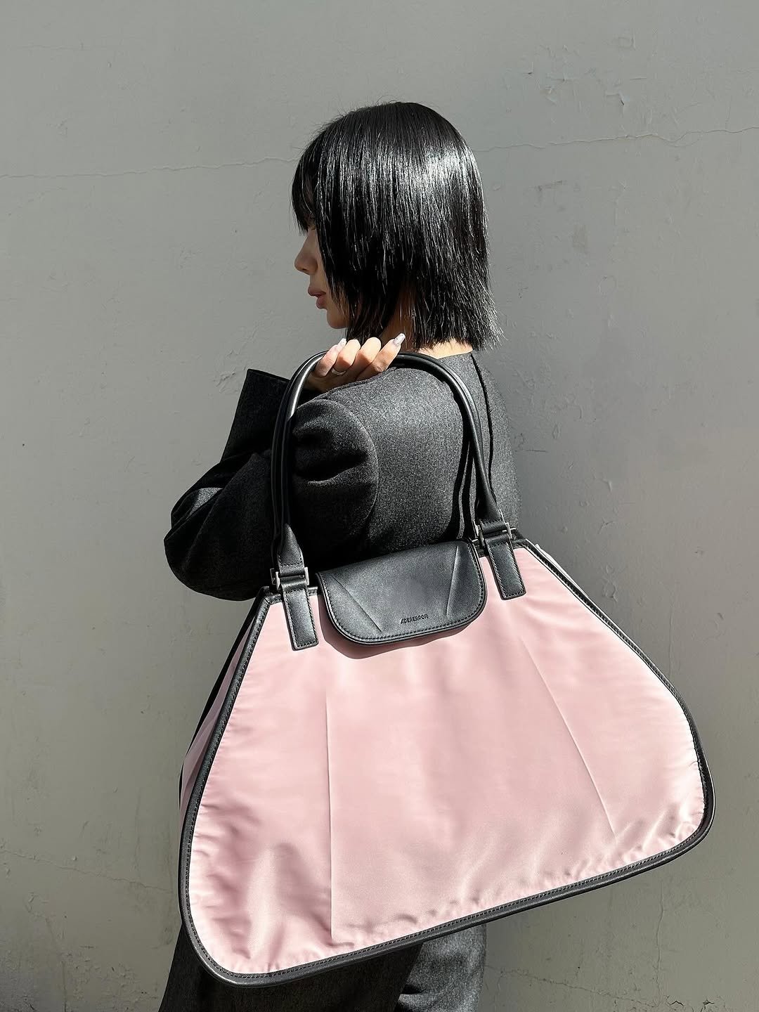 Photo by ADERERROR SPACE on October 12, 2025. May be an image of saddle-stitched leather, leather, drawstring, sling and text.