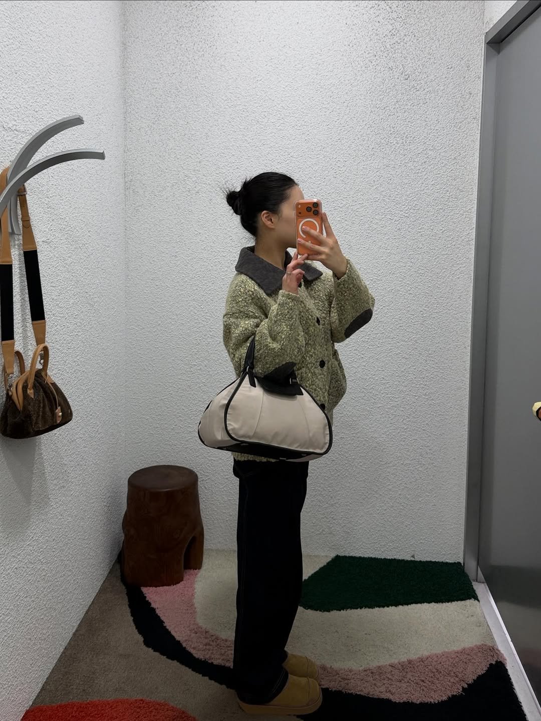 Photo by ADERERROR SPACE on January 19, 2026. May be an image of overcoat, duffle coat, fur, parka and text.