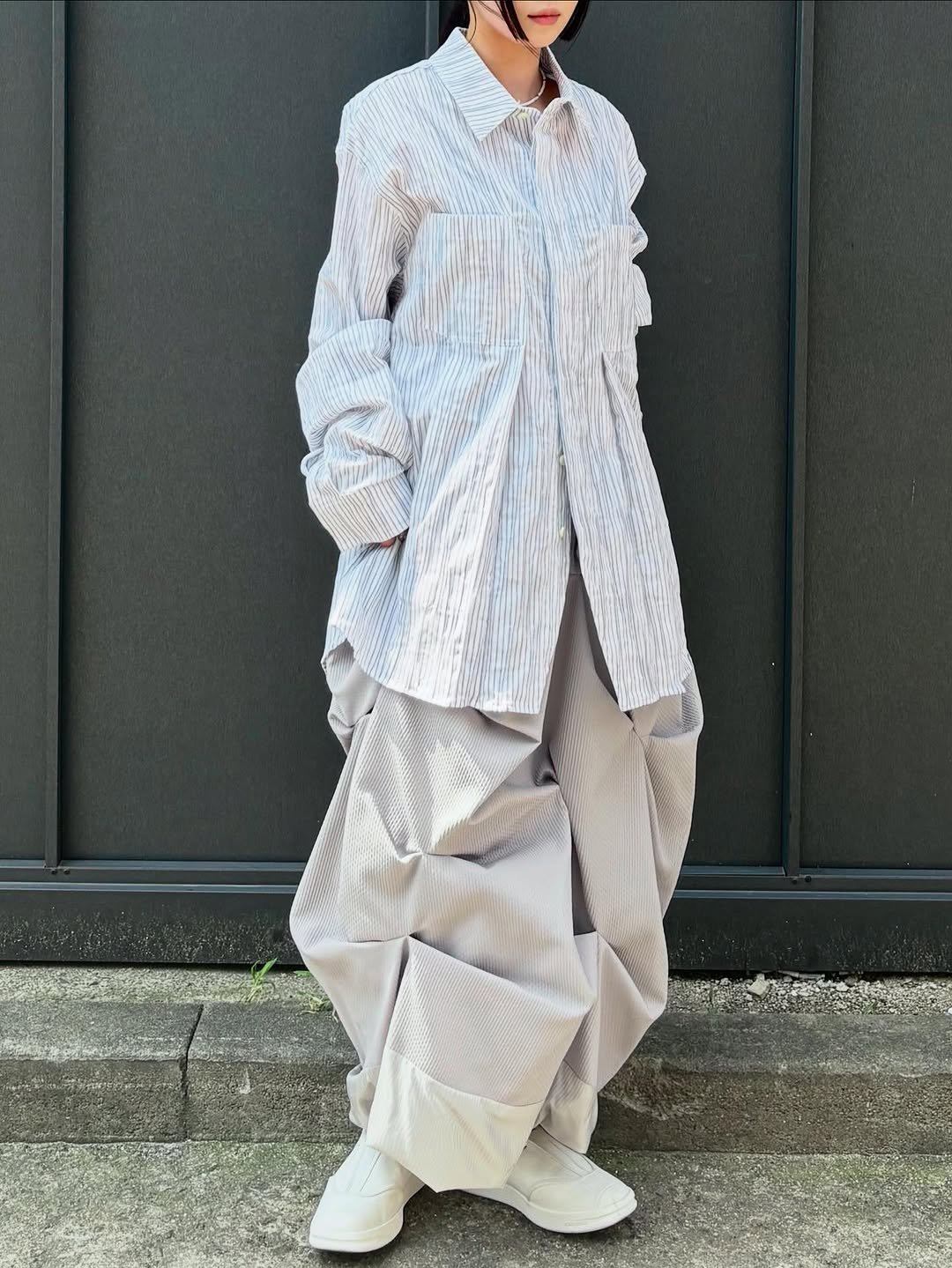 Photo by ADERERROR SPACE on September 01, 2025. May be an image of 1 person, overcoat and text.