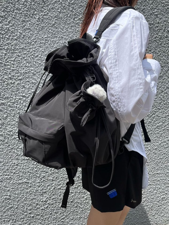 Photo by ADERERROR SPACE on August 31, 2025. May be an image of 1 person, tool bag, drawstring, sportswear and text.