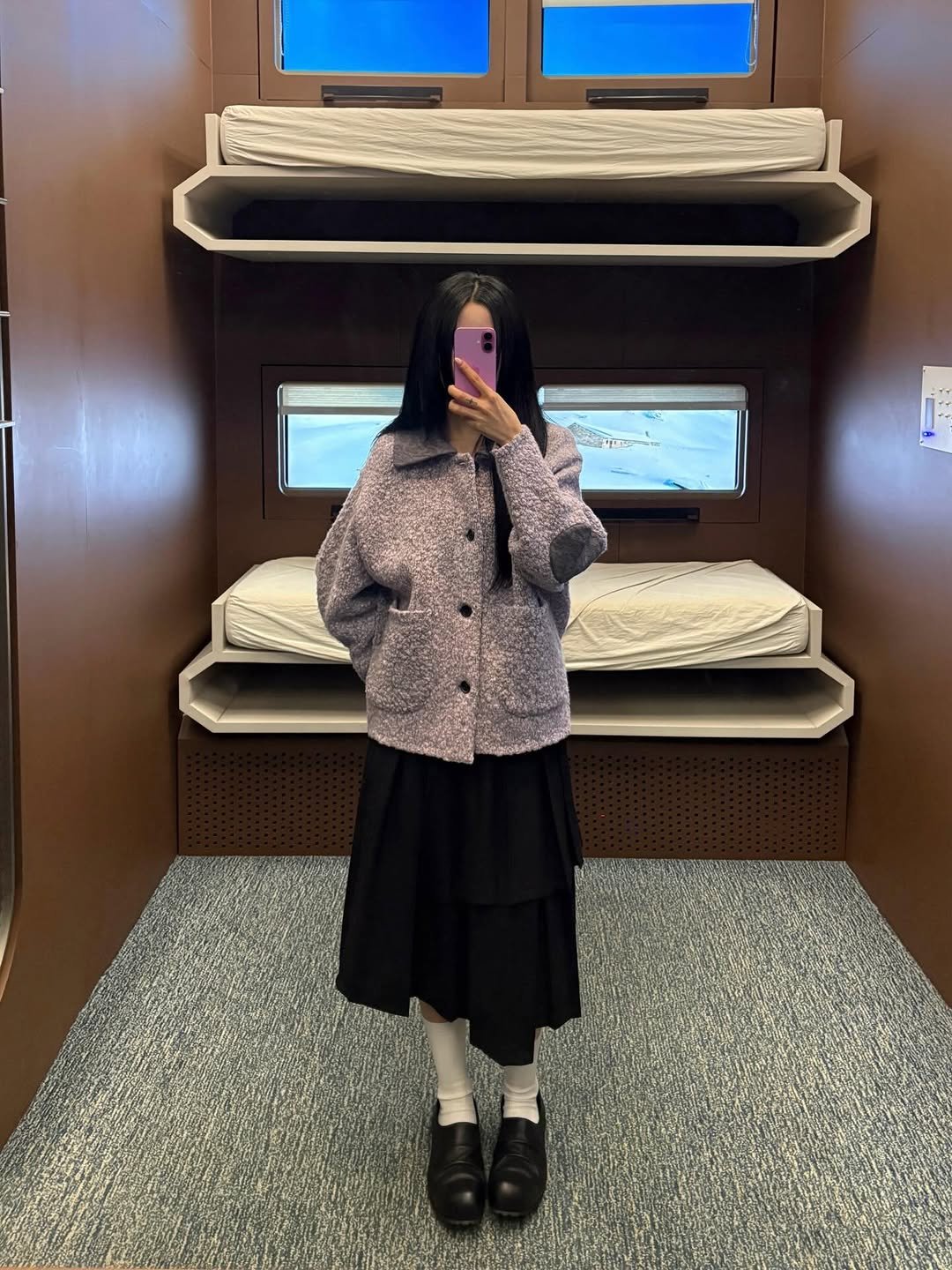 Photo by ADERERROR SPACE on January 18, 2026. May be an image of overcoat, duffle coat, bath robe, parka, turtleneck, bunk bed and text.