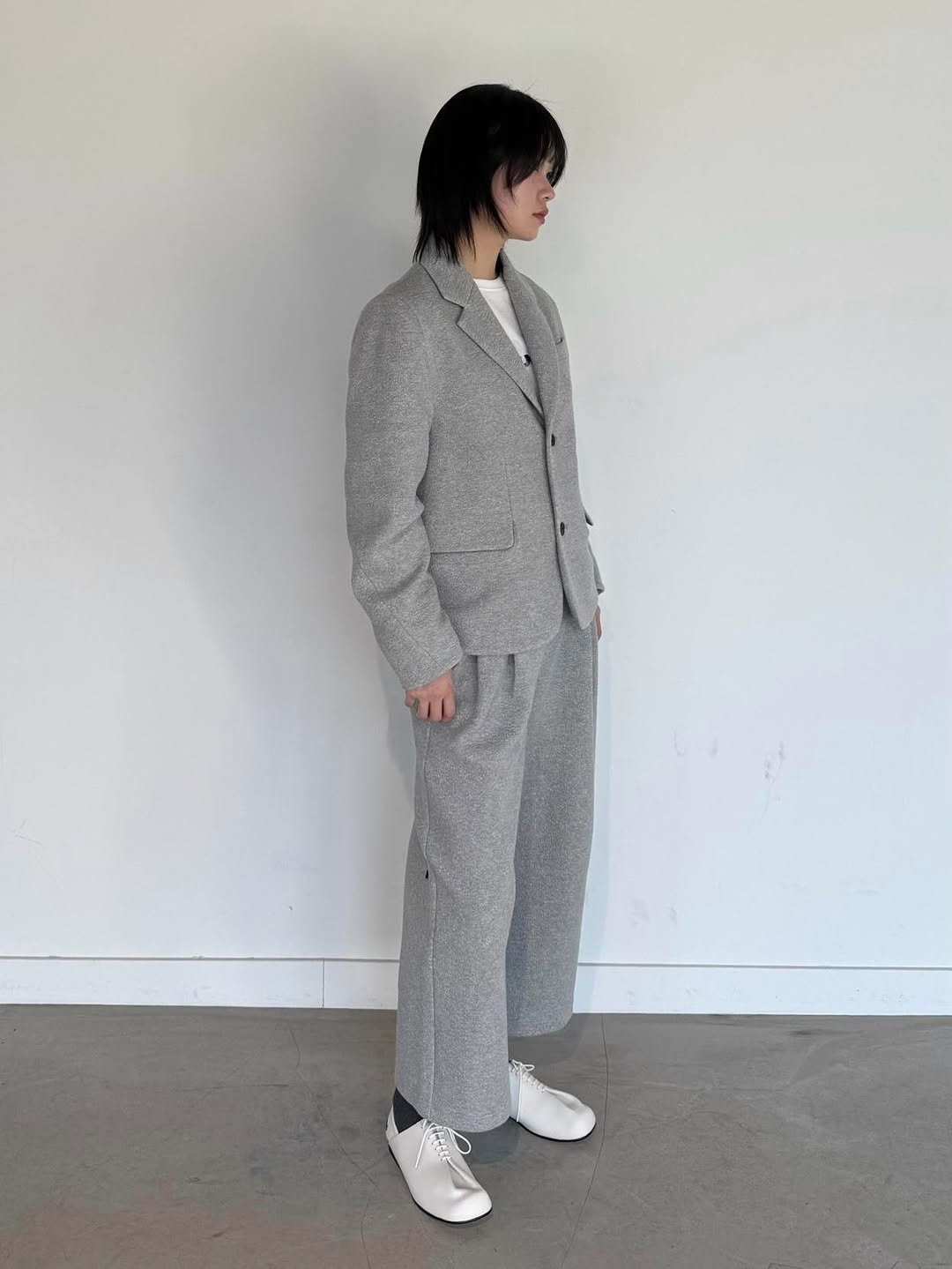 Photo by ADERERROR SPACE on February 04, 2026. May be an image of overcoat, wool, suit and text.