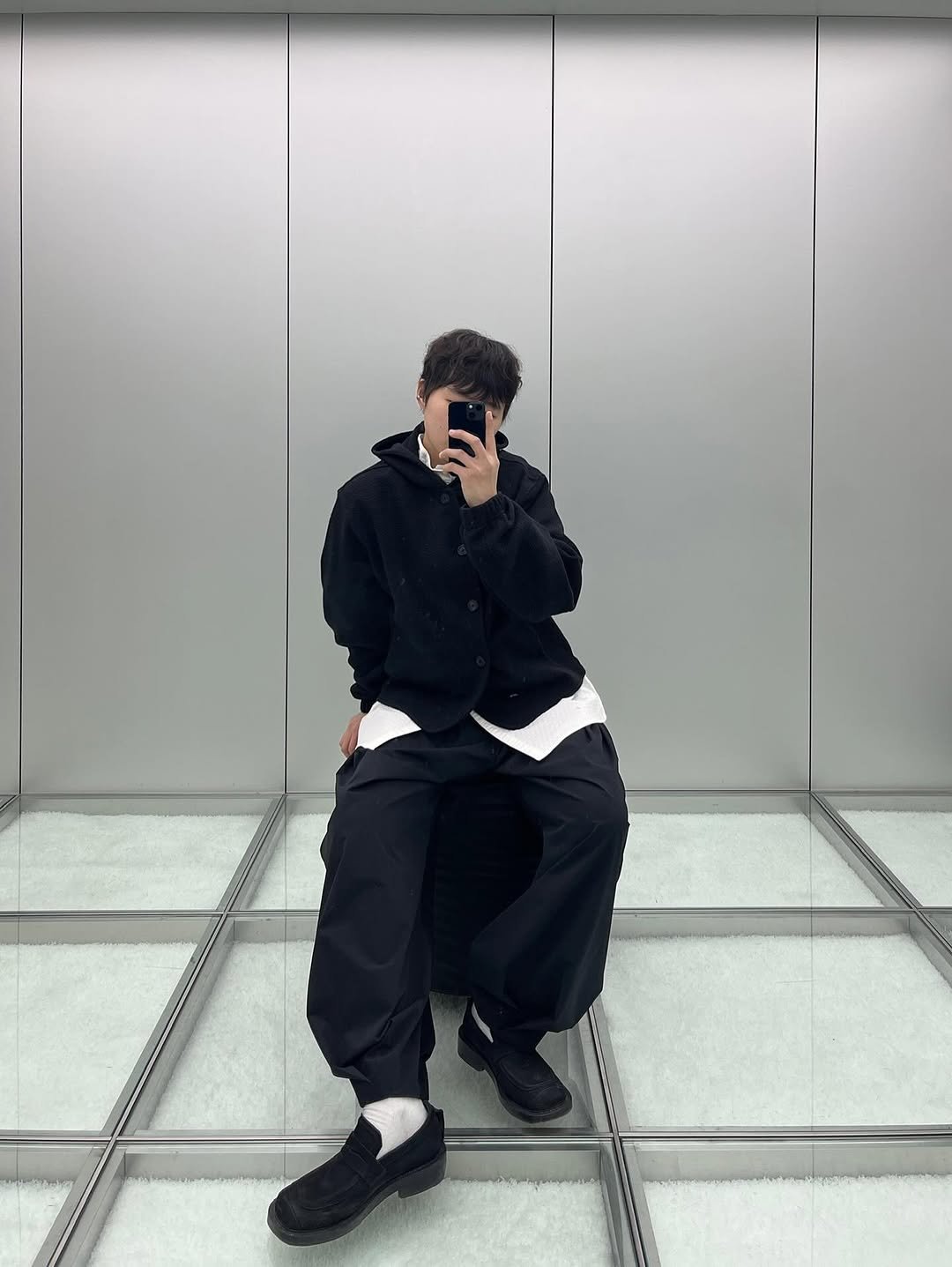 Photo by ADERERROR SPACE on January 31, 2026. May be an image of duffle coat, sweatpants, mirror, parka and text.