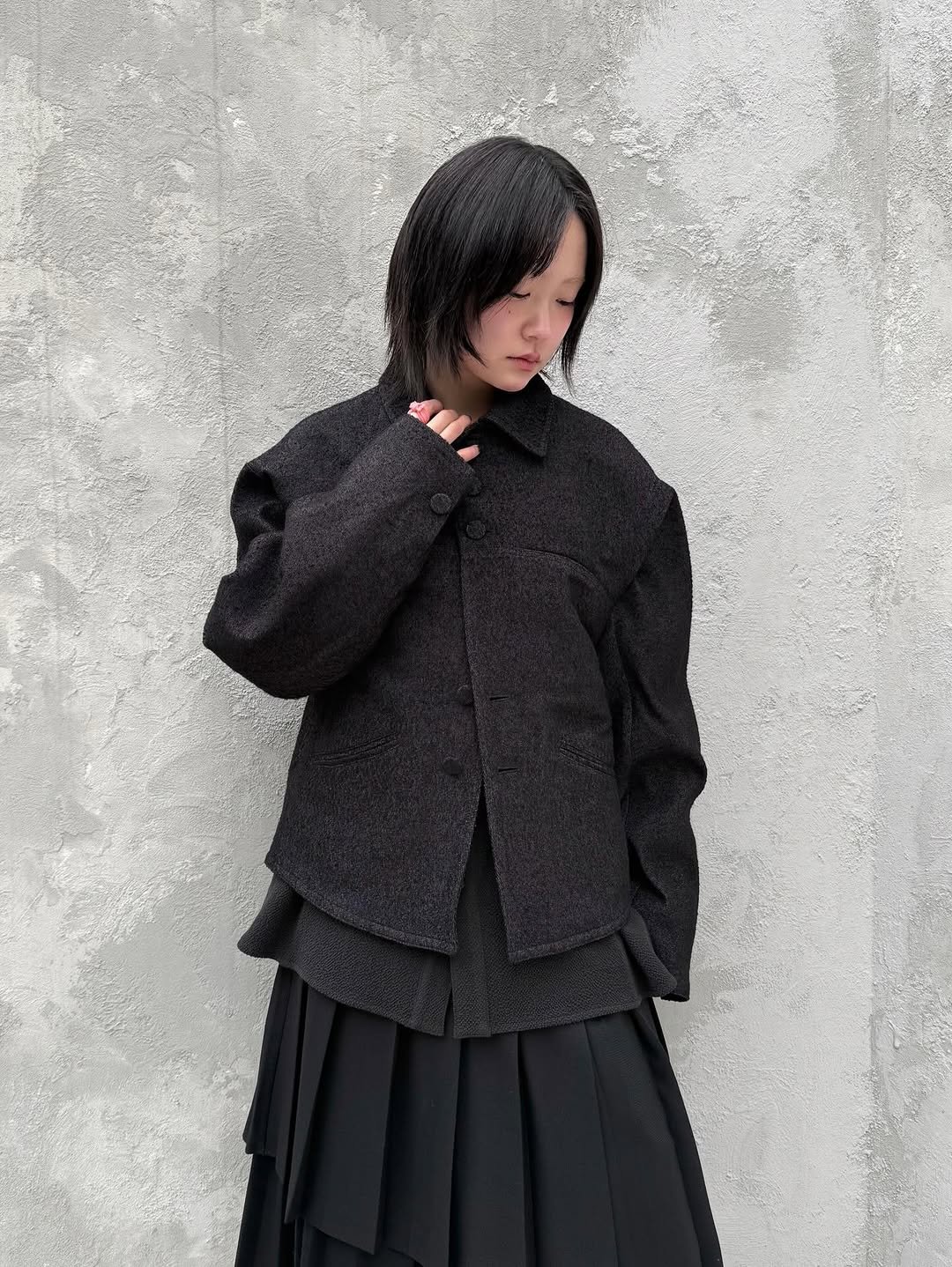 Photo by ADERERROR SPACE on February 16, 2026. May be an image of duffle coat, overcoat, blazer, suit and text.