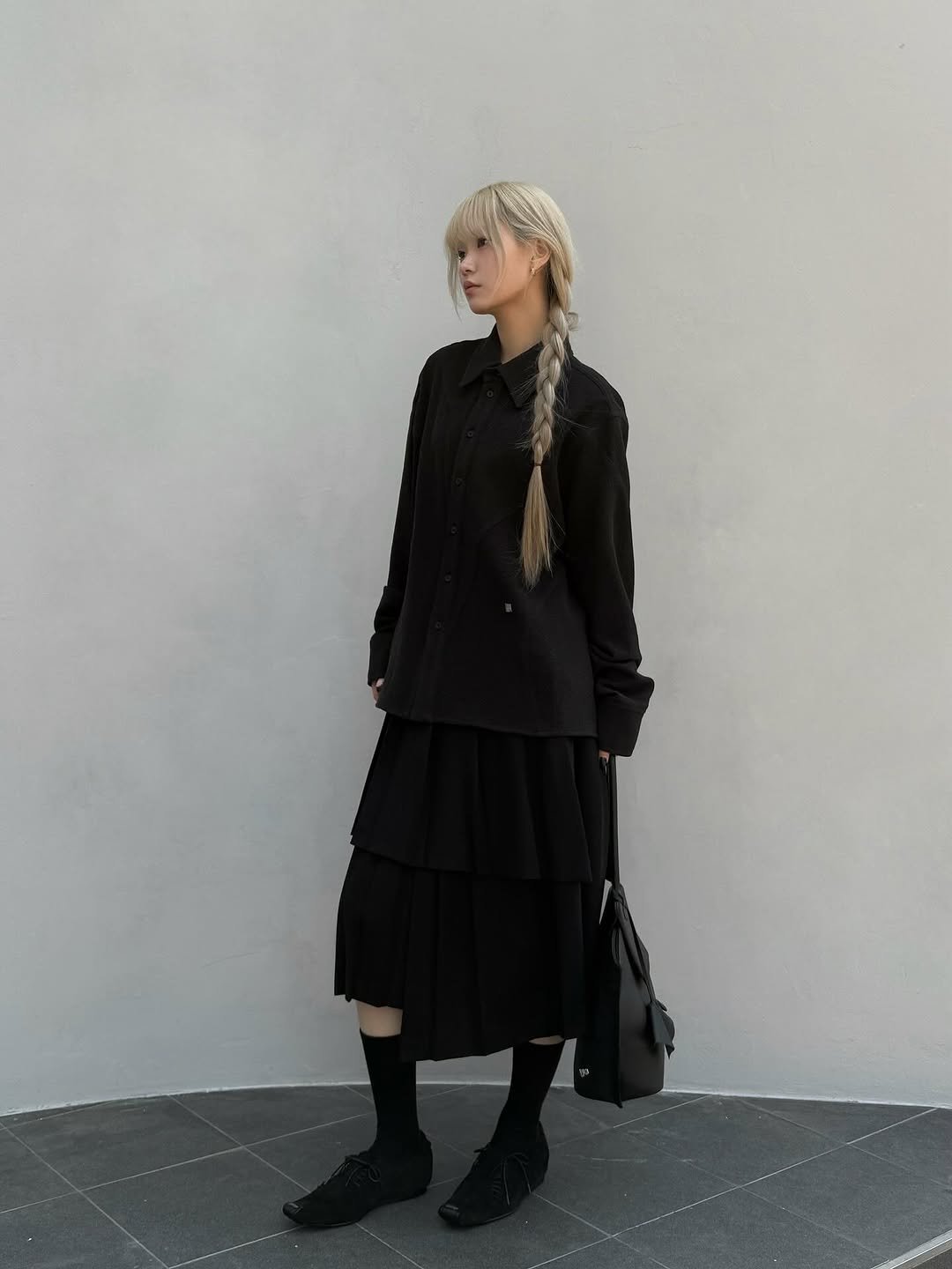 Photo by ADERERROR SPACE on October 06, 2025. May be an image of turtleneck, kilt and text.