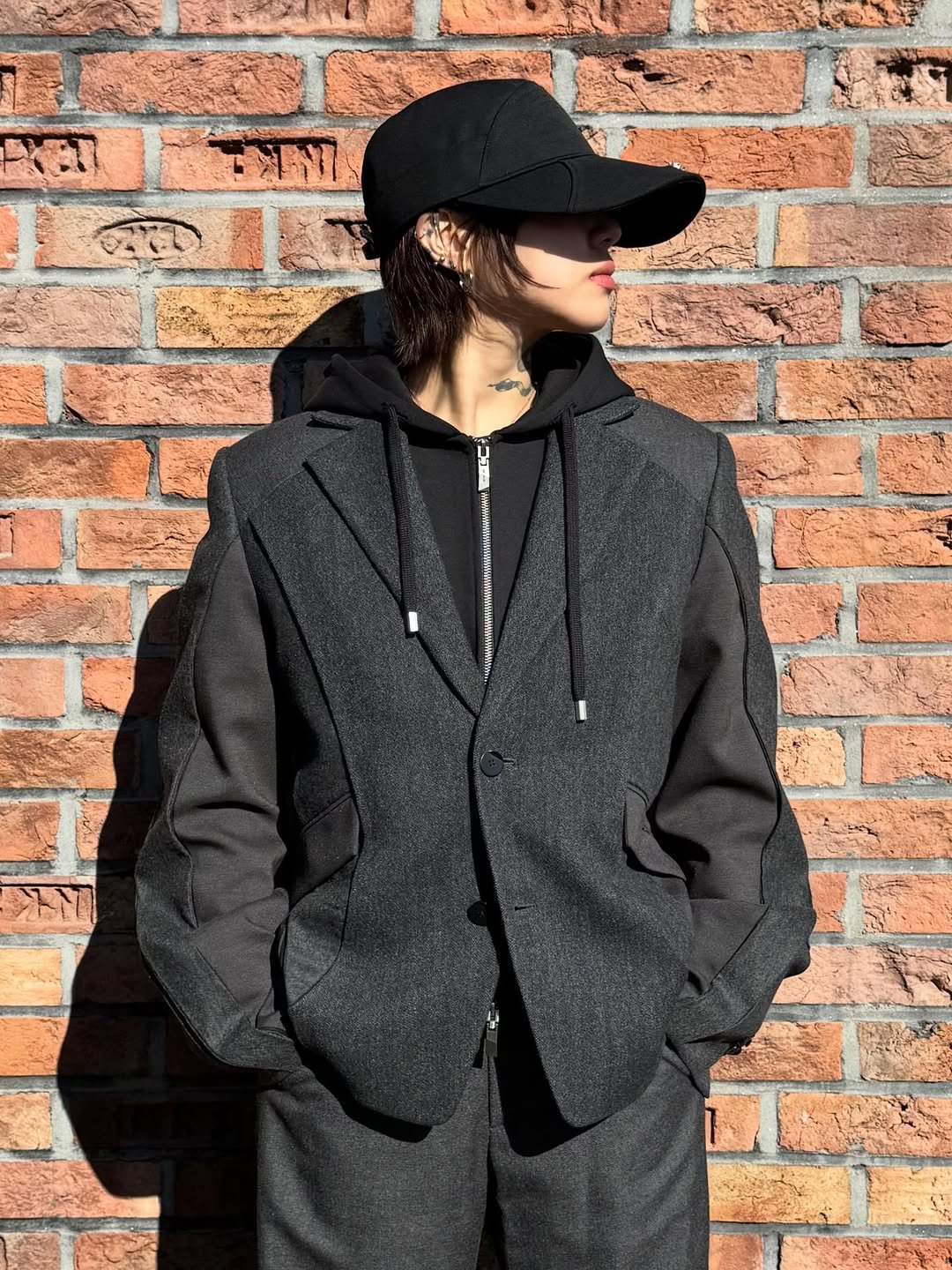 Photo by ADERERROR SPACE on January 22, 2026. May be an image of duffle coat, overcoat, hat, drawstring, parka, jacket, sweatpants and text.