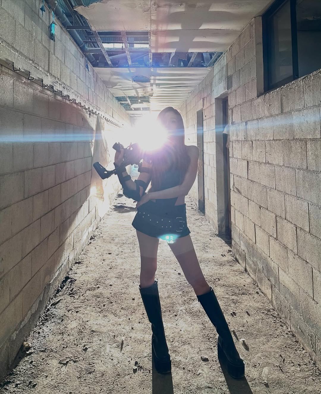 Photo by GISELLE on July 04, 2025. May be an image of 1 person, standing, miniskirt, fishnet stockings, hallway and text.