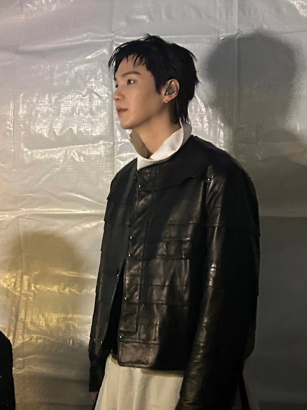 Photo by SUGA of BTS 민윤기 on March 23, 2026. May be an image of one or more people, bangs, bolo tie, top and text.