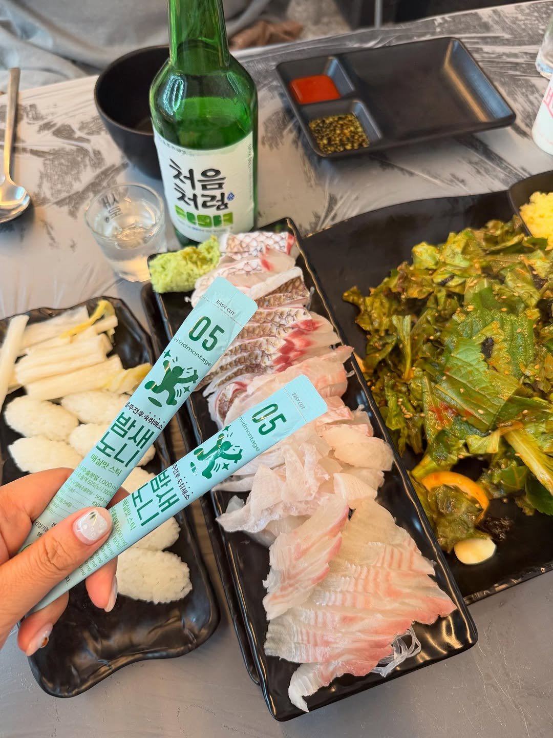 Photo shared by 아힌🍓 on August 05, 2025 tagging @vividmontage_. May be an image of sashimi, chopsticks and text.
