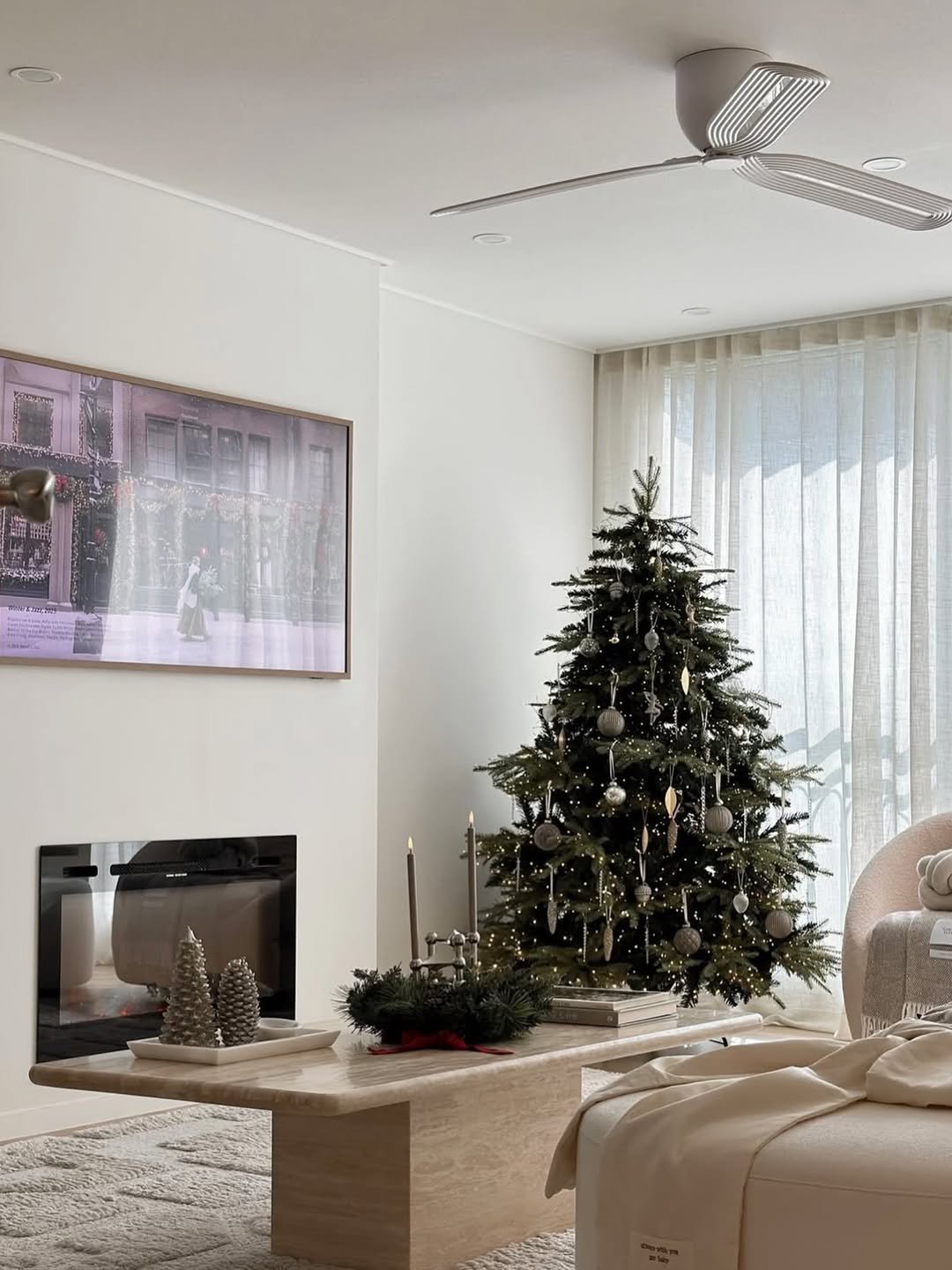 Photo shared by 에어블로우 on December 15, 2025 tagging @airblow_official. May be an image of christmas tree, lighting, fireplace, sofa, indoors, living room and text.