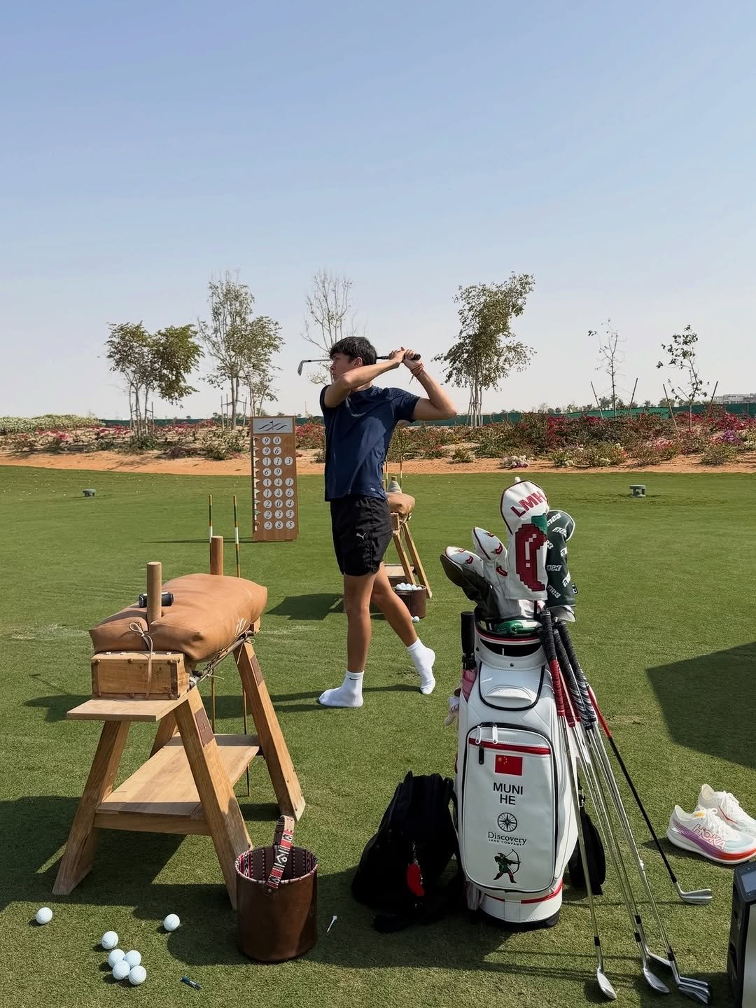 Photo shared by Alex Albon on February 09, 2026 tagging @lilymhe. May be an image of golf, golf club, golf course and text that says 'DO A MUNI HE 輪 Discuyary'.