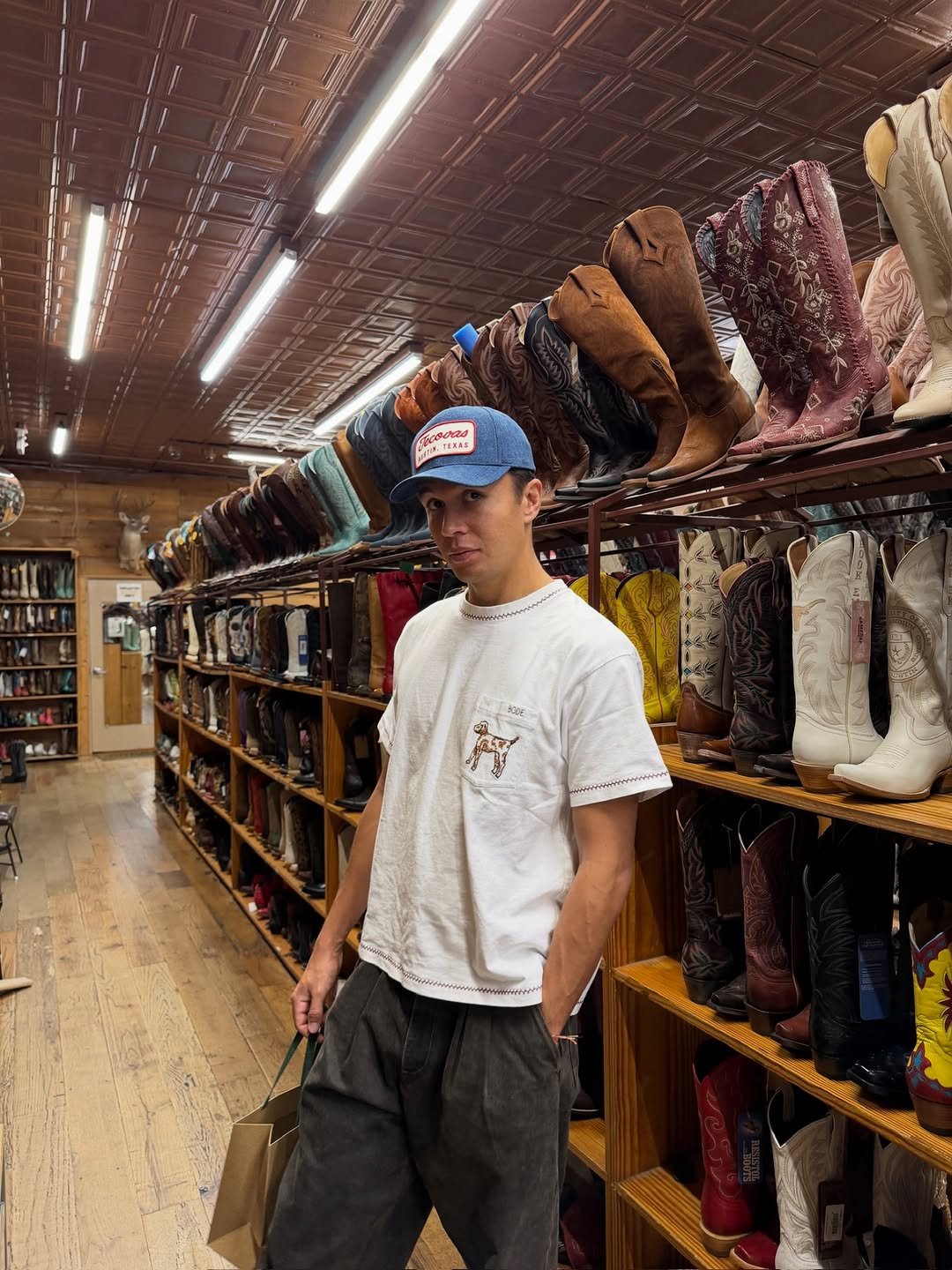 Photo by Alex Albon on October 21, 2025. May be an image of boots, hat shop and text.