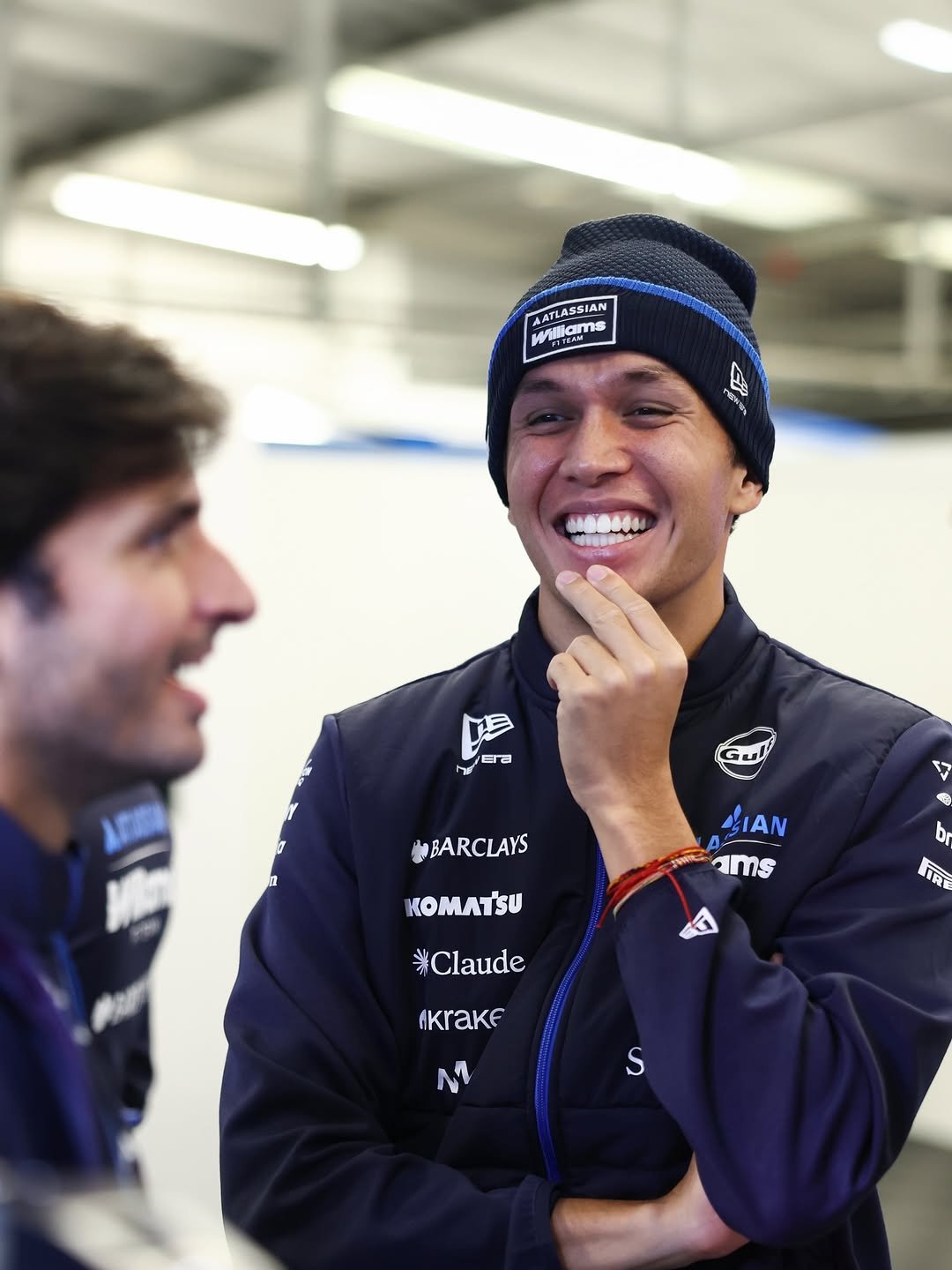 Photo shared by Alex Albon on February 04, 2026 tagging @carlossainz55, and @williamsf1official. May be an image of racing vehicles, helmet and text.