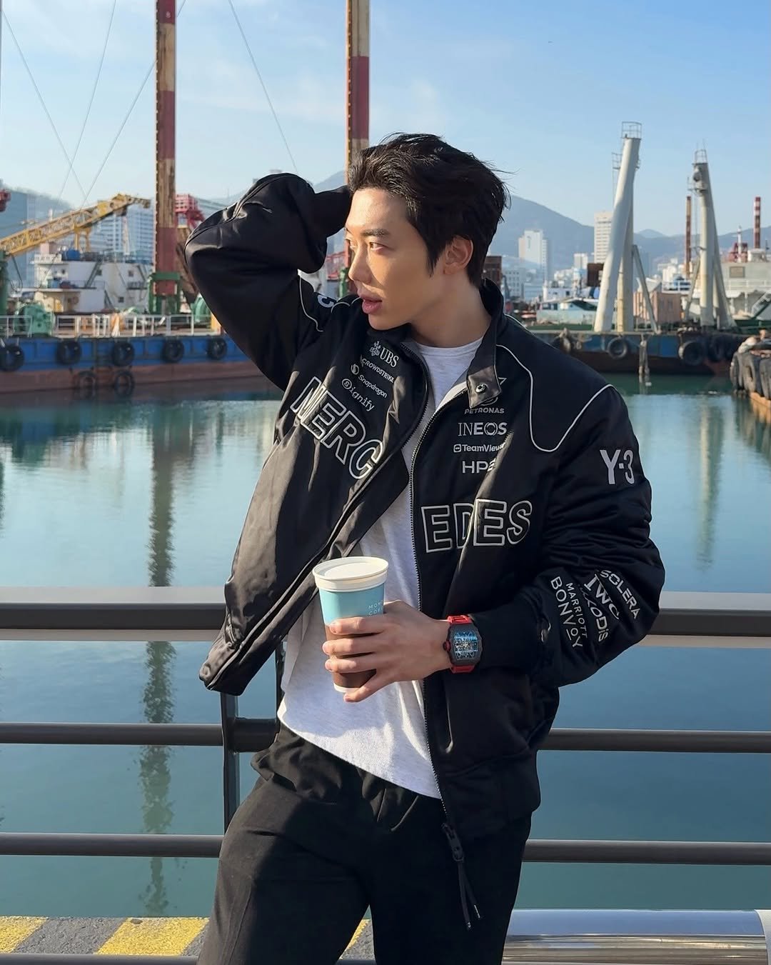 Photo shared by Jihoon Kim on April 11, 2026 tagging @adidasy3, and @mercedesamgf1. May be an image of parka, flight jacket, cornflower and text.