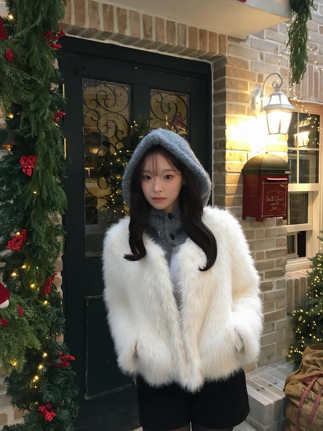 Photo by 예진 Yejin on December 30, 2025. May be an image of jacket, fur, turtleneck, parka, coat, miniskirt and sweater.
