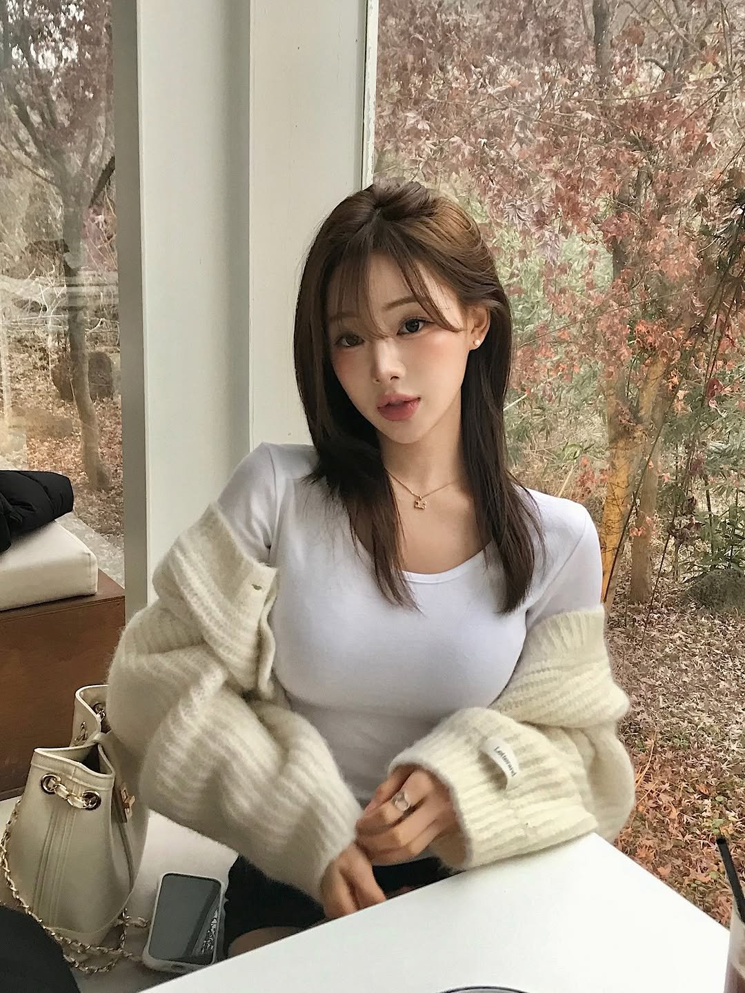 Photo by 다영 ALLZEROK on December 28, 2025. May be an image of one or more people, hair, top, turtleneck, parka, knit and text.