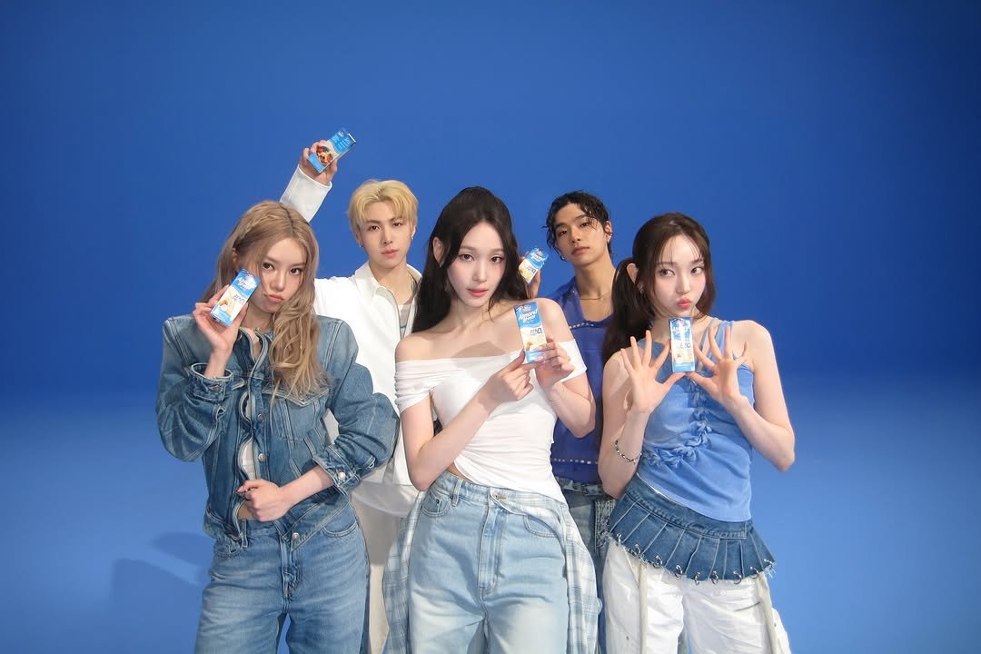 Photo shared by ALLDAY PROJECT on April 22, 2026 tagging @almondbreezekorea. May be an image of one or more people, bangs and text.