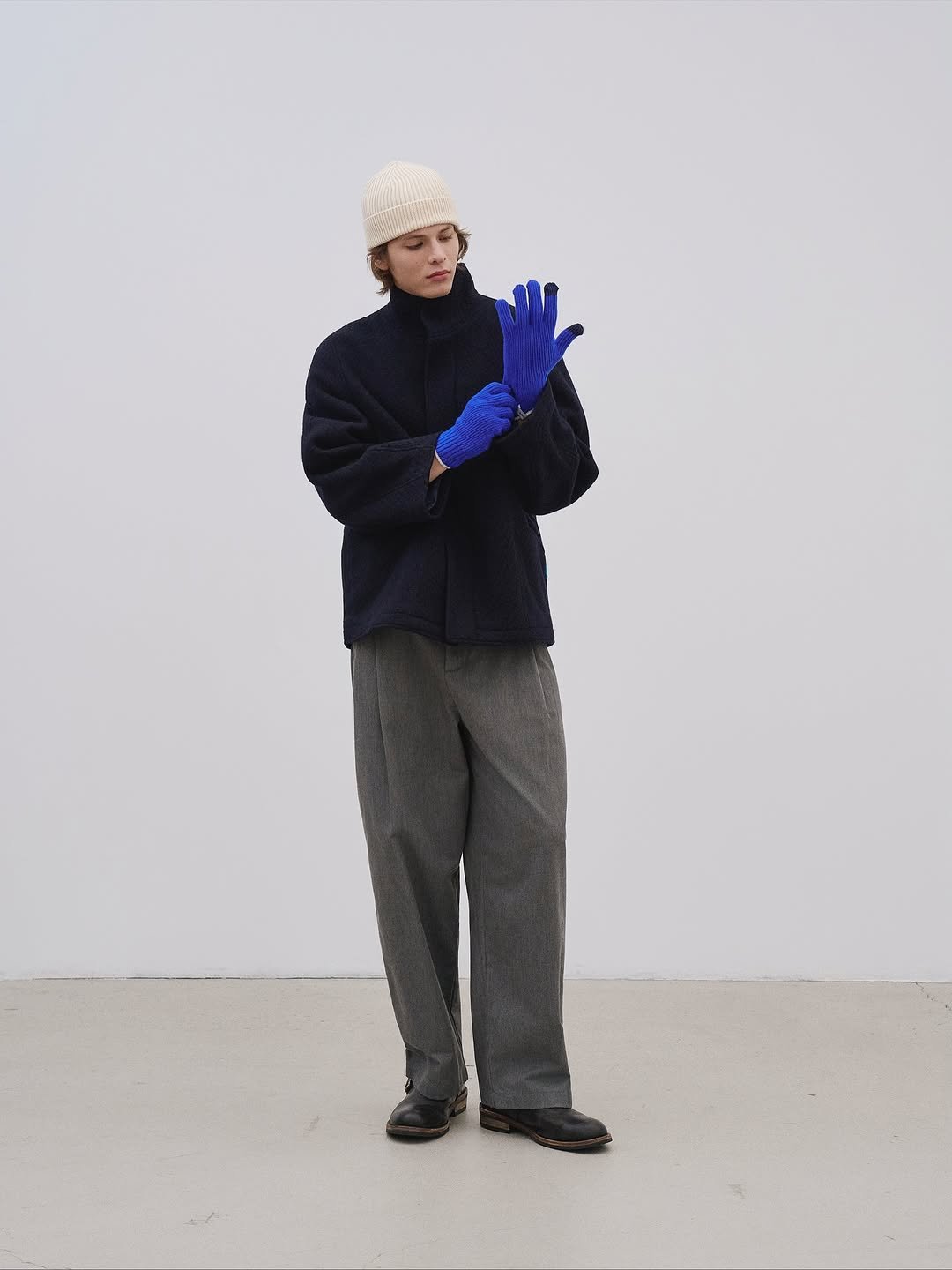 Photo by AMOUPRE 아모프레 on October 17, 2025. May be an image of turtleneck, wool, face mask and text.