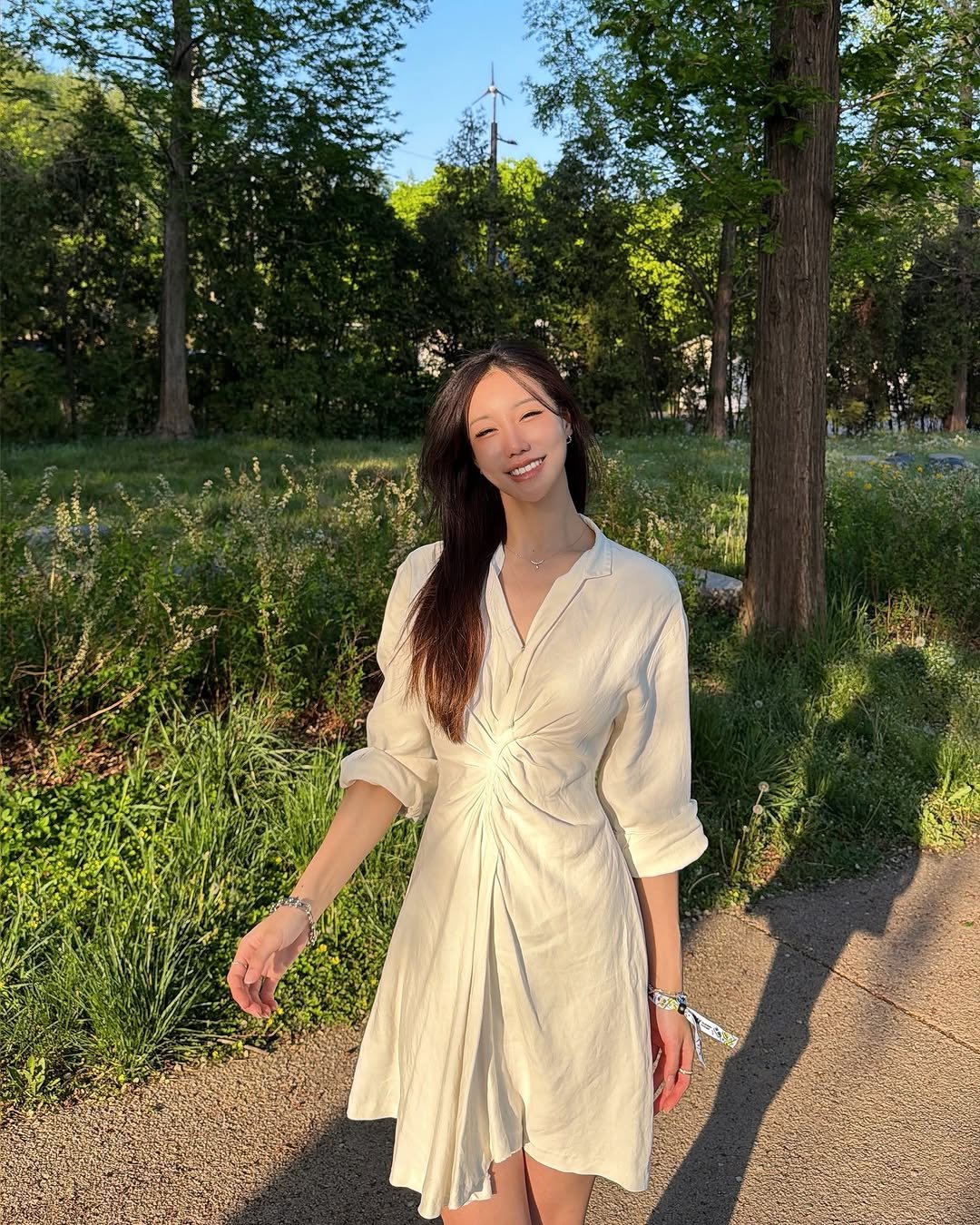 Photo shared by jina 진아 on April 26, 2026 tagging @ana_yaksa. May be an image of sundress, grass, park and text.