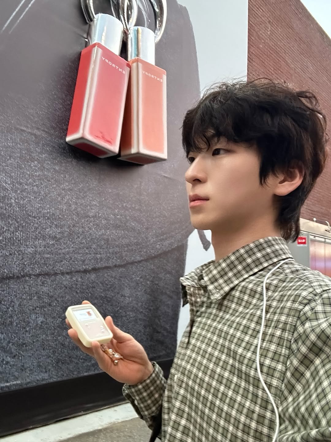Photo shared by 안찬혁 on September 30, 2025 tagging @entropymakeup. May be an image of 1 person, duffle coat, phone and text that says 'SORTHN и3 六'.