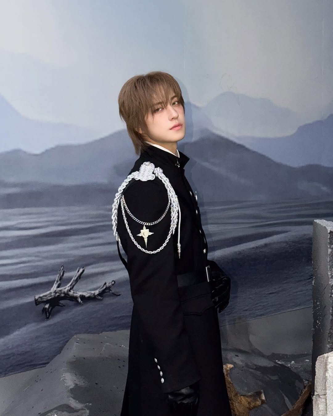 Photo by &TEAM on March 25, 2026. May be an anime-style image of military uniform, costume, cloak, eye patch and text.