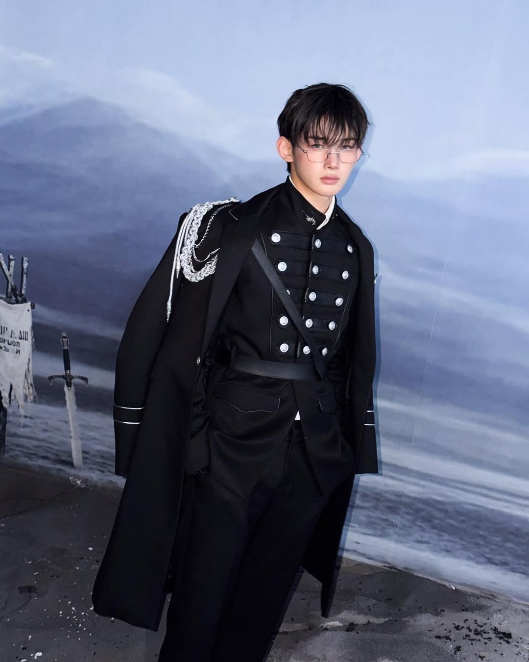 Photo by &TEAM on March 25, 2026. May be an image of overcoat, suit, duffle coat, bolo tie, military uniform, dinner jacket, blazer and text.