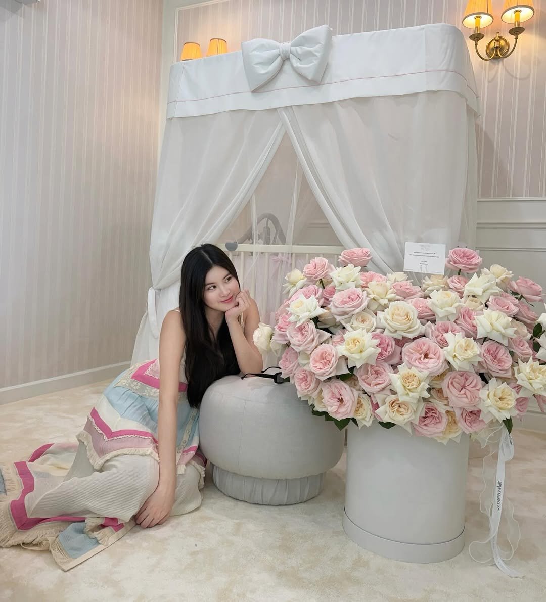 Photo shared by Somrutai Rattanawaraha on November 25, 2025 tagging @mothergoosethailand. May be an image of baby bed, flower arrangement, prairie gentian, rose and text.