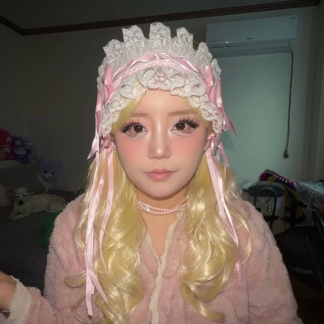 Photo by 아람이 on January 08, 2026. May be an image of one or more people, makeup, costume, bath robe, headdress and text.