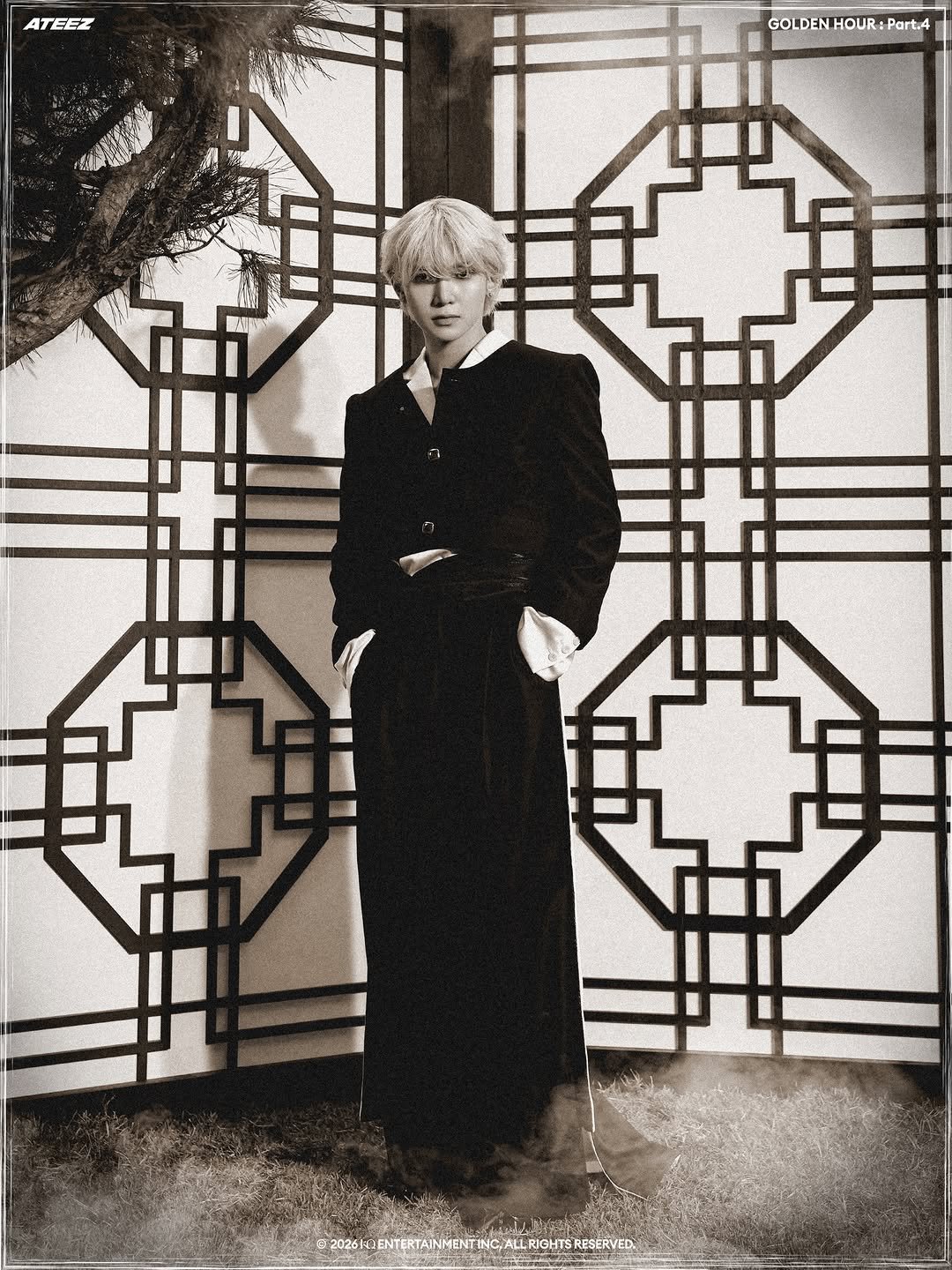 Photo shared by ATEEZ(에이티즈) on January 13, 2026 tagging @im_ovation. May be a black-and-white image of duffle coat, overcoat, cloak, bolo tie and text.