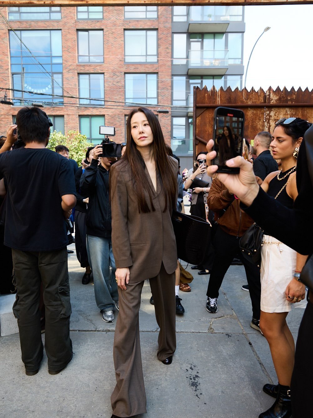 Photo shared by 고현정 on September 14, 2025 tagging @cosstores. May be an image of 7 people, coat and text.