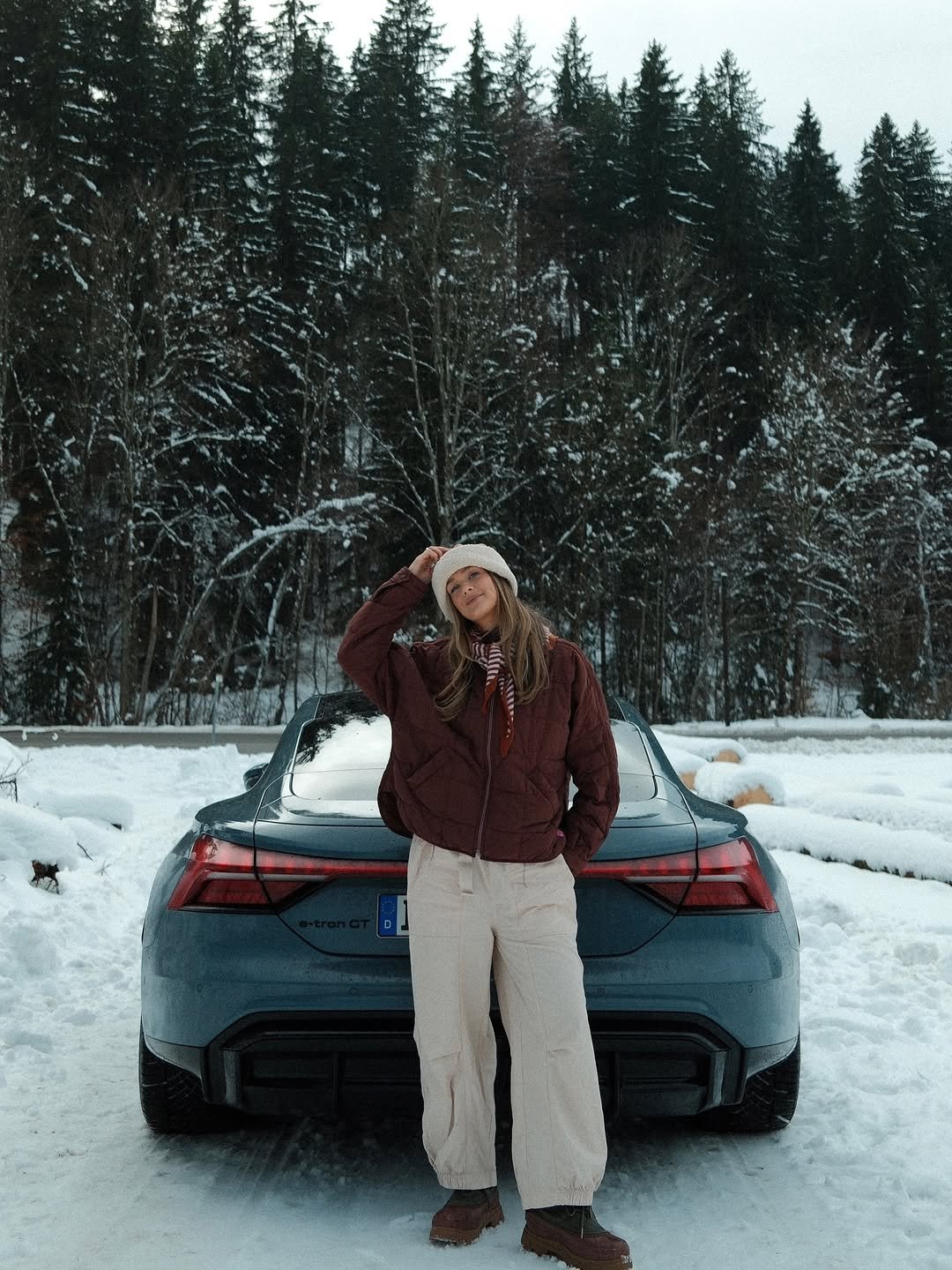Photo shared by Louisa Schmolke Art on December 27, 2025 tagging @audi. May be an image of standing, car, snowsuit, road, snow and text.