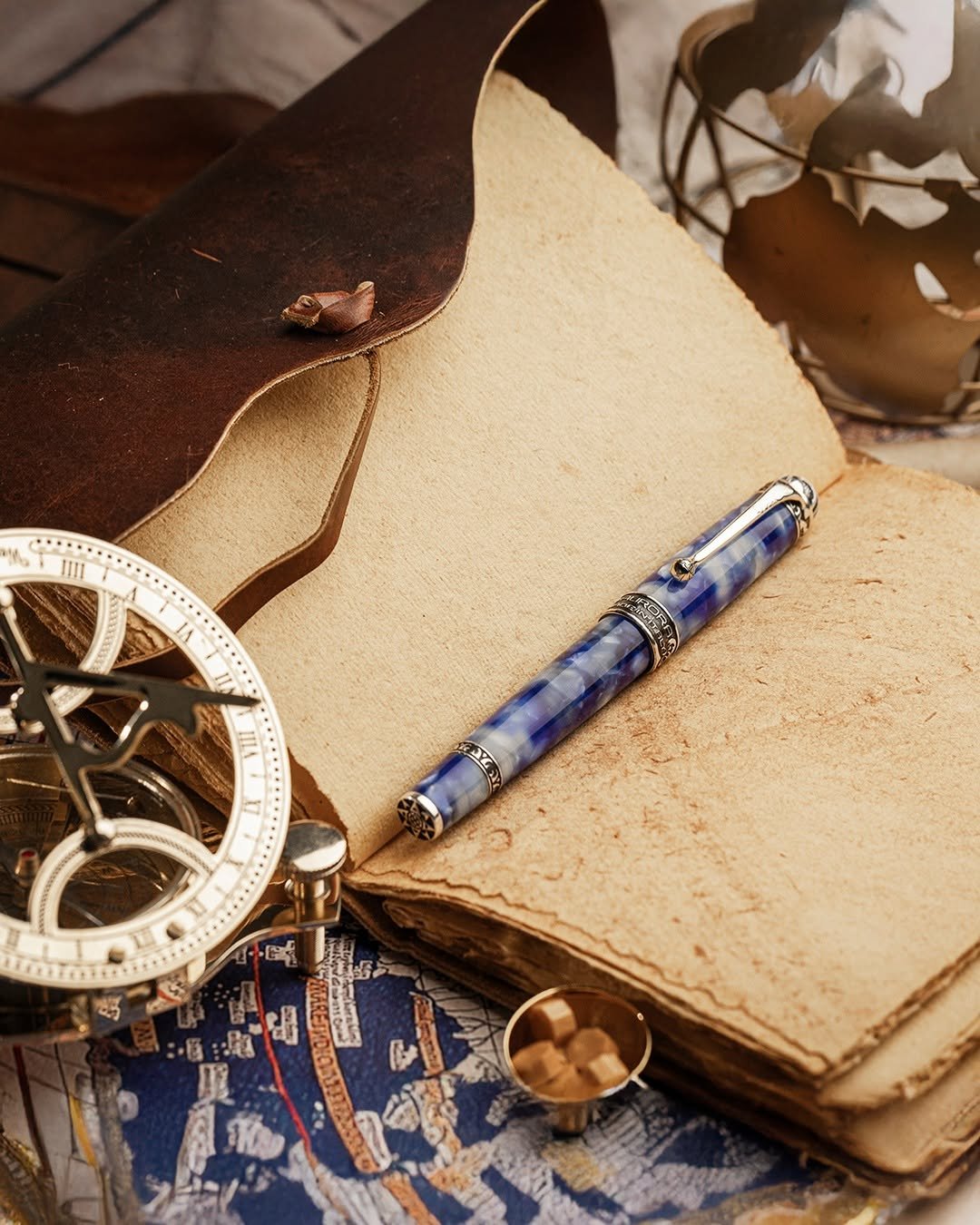 Photo by Aurora Pen in Aurora Pen. May be an image of saddle-stitched leather, diary, leather, leather wallet, pocketwatch, pen, briefcase and text.