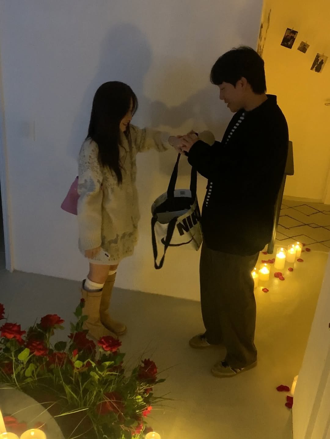 Photo by 영아 on October 31, 2025. May be an image of people kissing, candle holder, candle, lantern, flower, carnation and text.