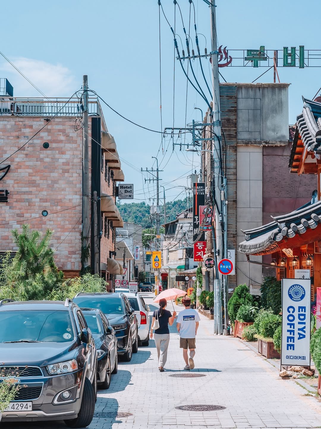 Photo shared by 빈백 | CHANG SU, OH on August 14, 2025 tagging @trazy_korea, @sonykorea, @suwon_city, @seoul.southkorea, @gyeonggi_tour, @gyeonggi__official, @visitkorea_travel, and @southkorea.explores. May be an image of 2 people, street, telephone pole, buildings and text.