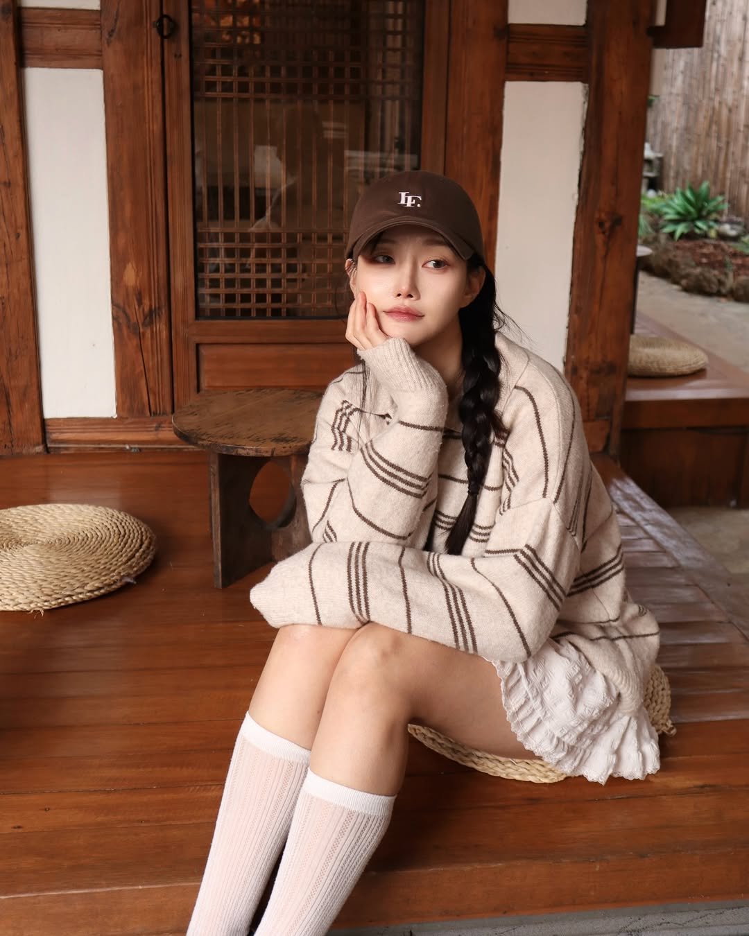Photo shared by 변민서 on December 16, 2025 tagging @lenav_u. May be an image of hat, knit, beret, sweater, miniskirt and text.