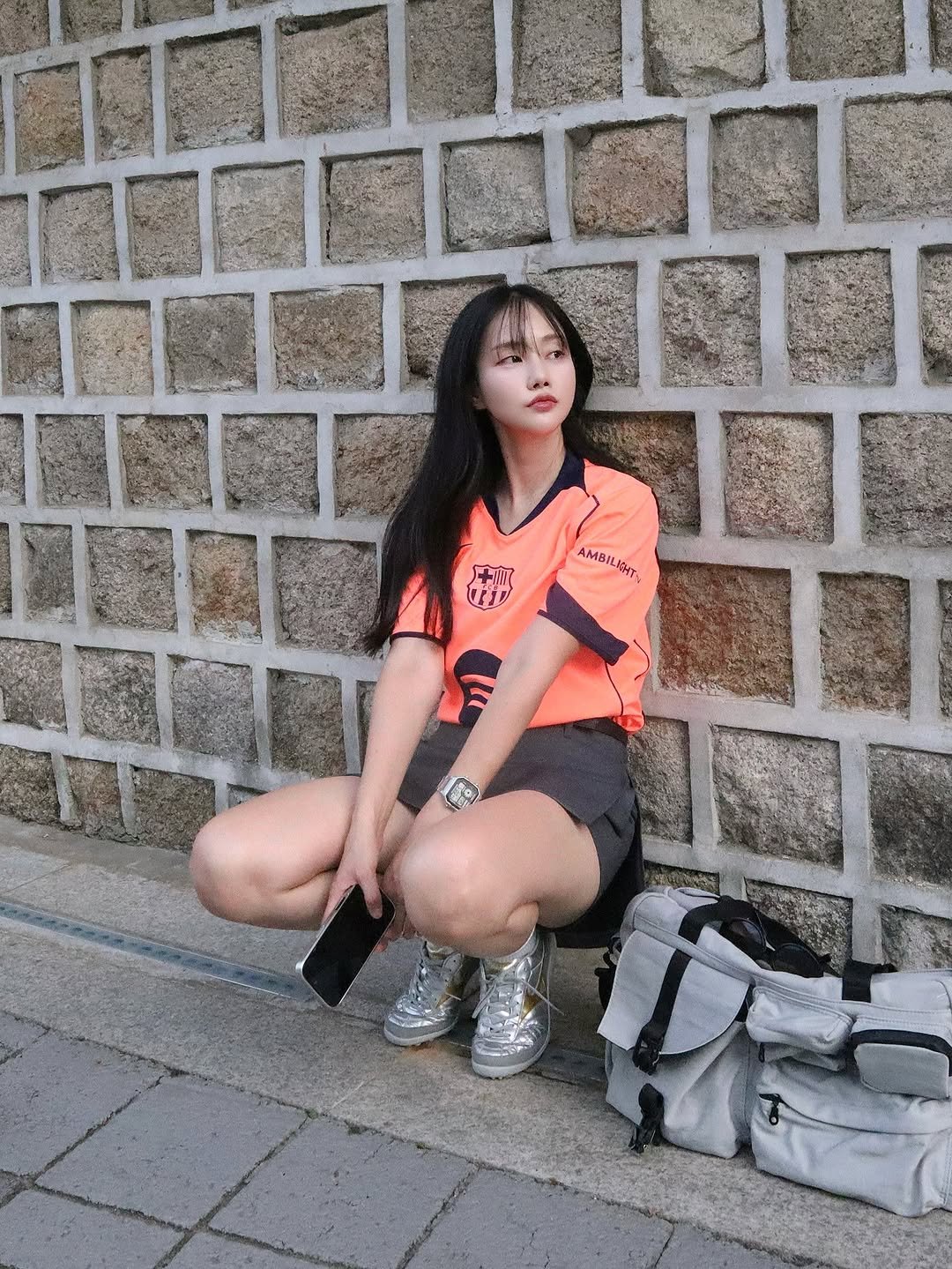 Photo by 변민서 on September 09, 2025. May be an image of 1 person, sportswear, miniskirt, parka, top, shorts, brick wall and text.