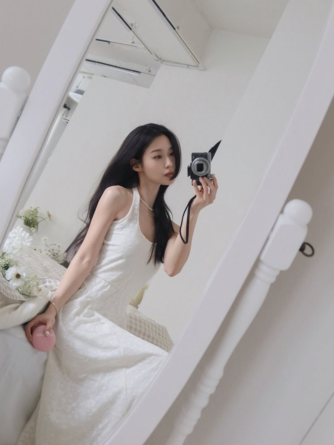 Photo shared by 바다 bada on April 01, 2026 tagging @diorbeauty. May be an image of sleepwear, phone, slip, mirror, chemise, dress, white lily and text.