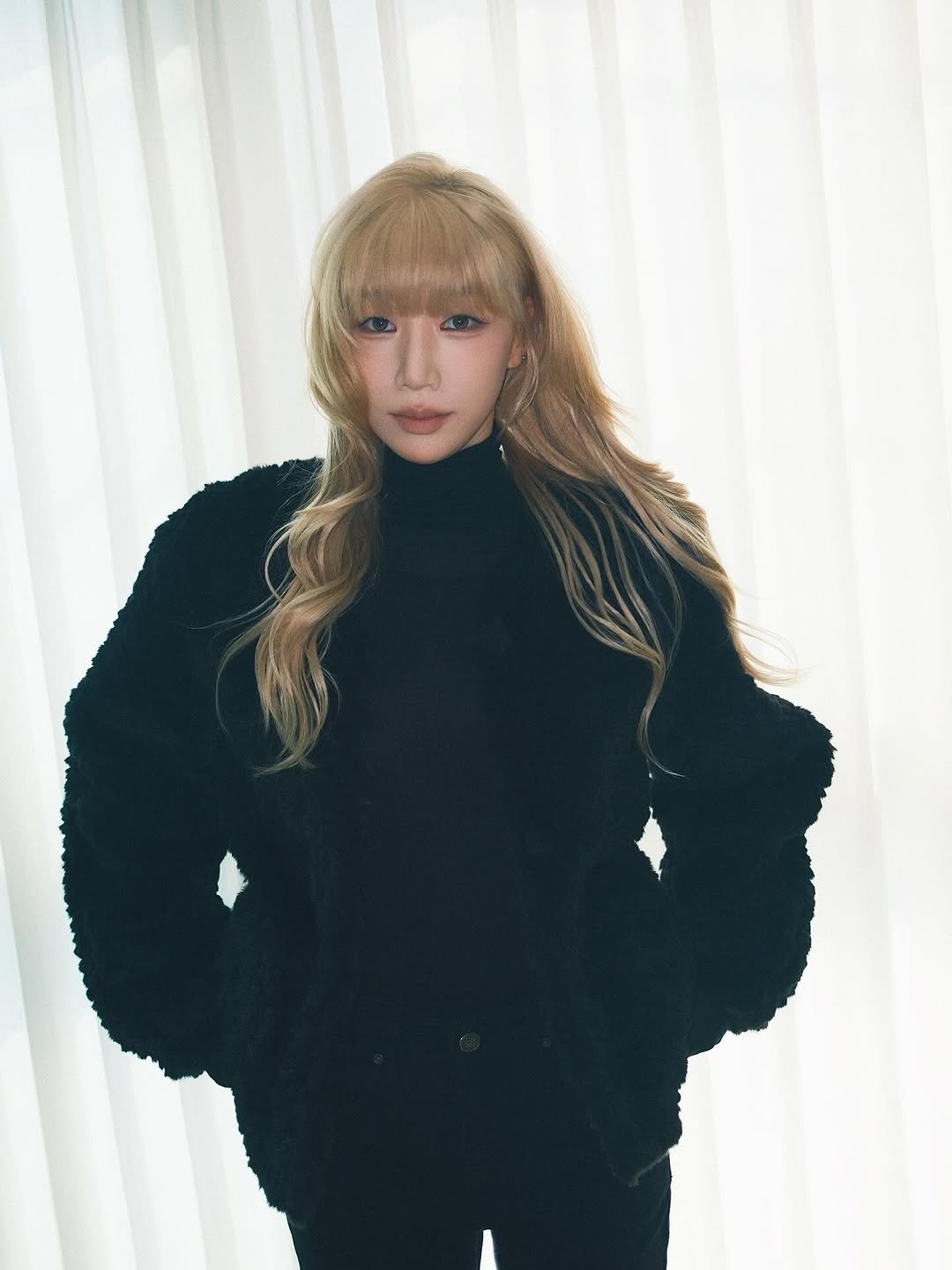 Photo shared by Bada Lee 바다 on March 21, 2026 tagging @mayv_jinju, @mayv_una, and @mayv_exex. May be an image of one or more people, bangs, blonde hair, turtleneck and text.
